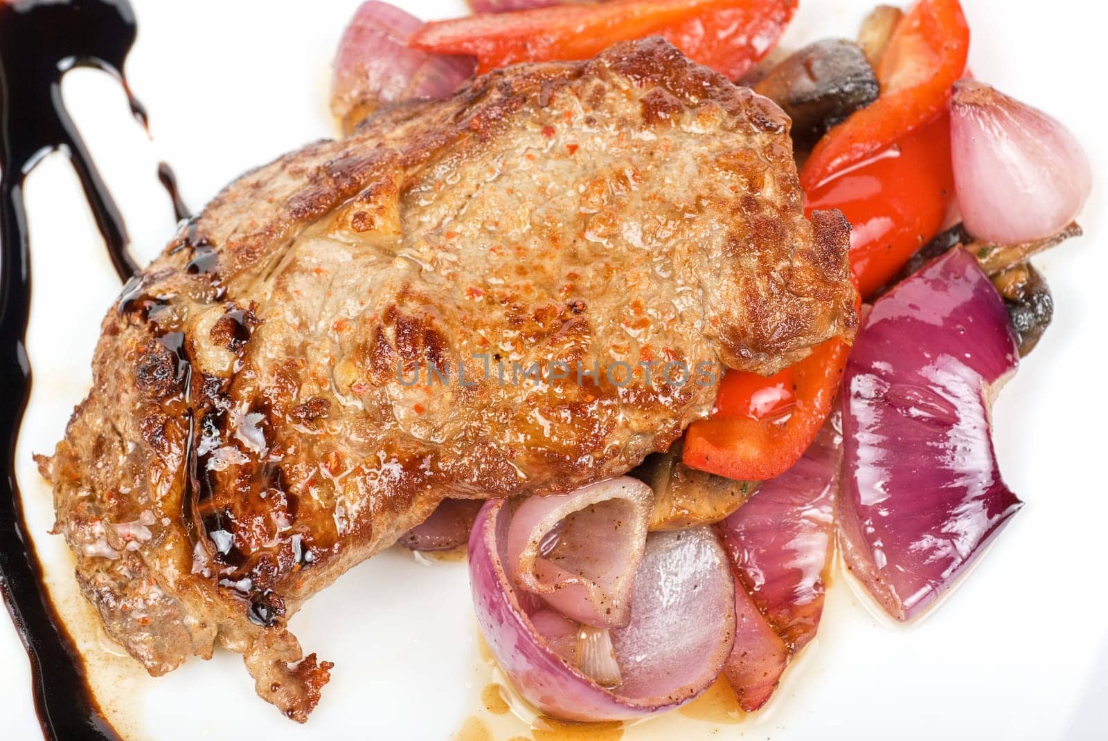 Roasted beef steak with vegetable closeup at plate