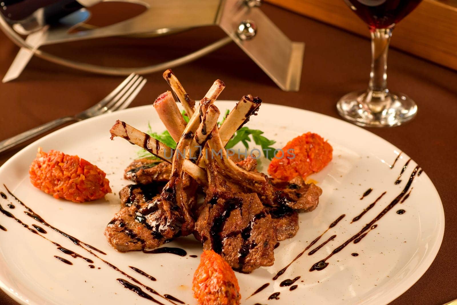 Roasted lamb chops with vegetables on decorated table