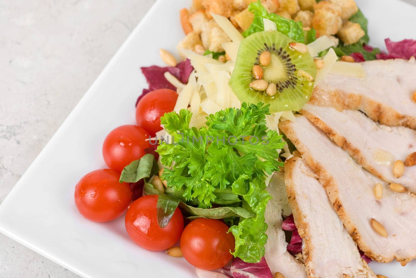 Tasty appetizer of meat, cherry tomato, greens and groundnut