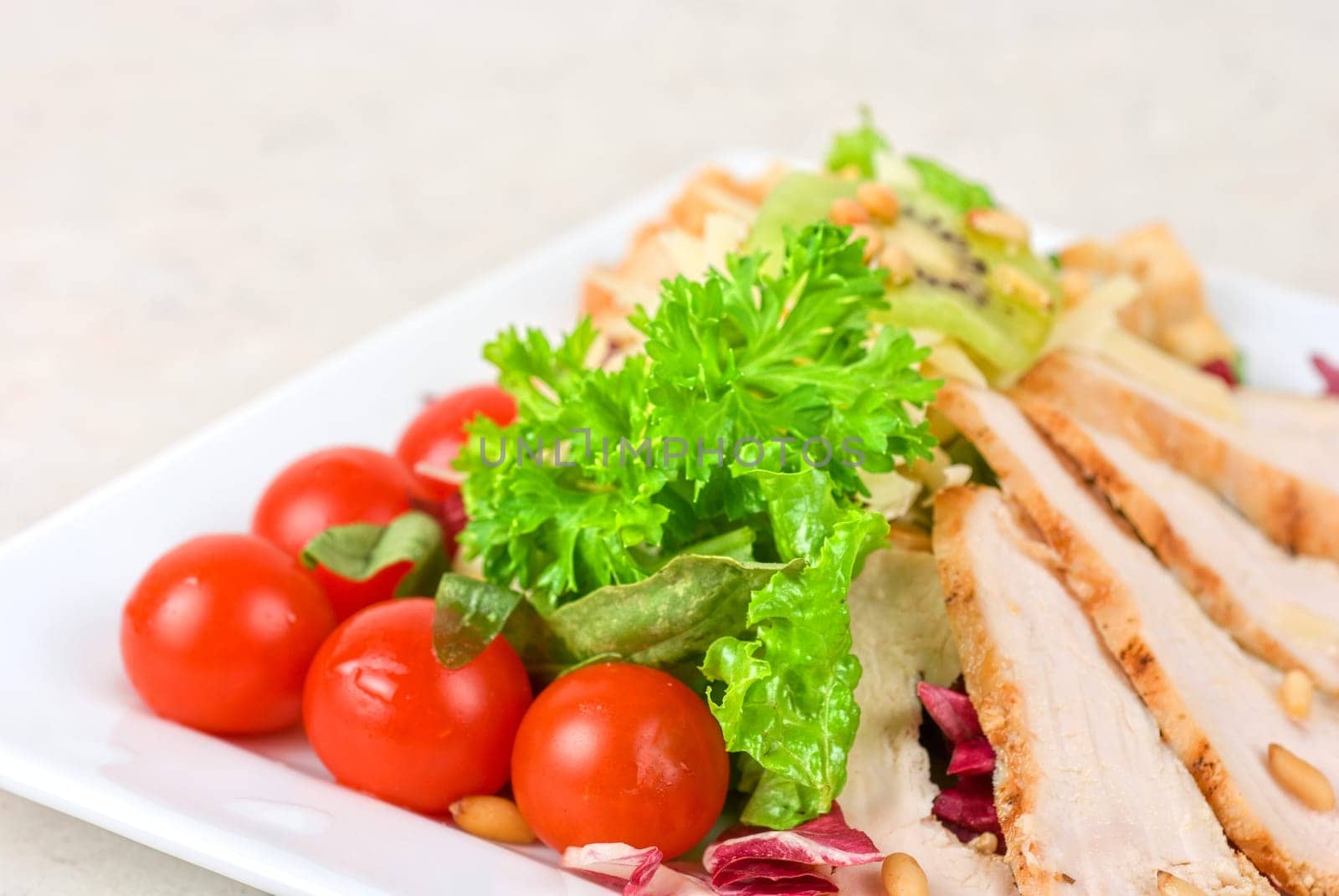 Tasty appetizer of meat, cherry tomato, greens and groundnut
