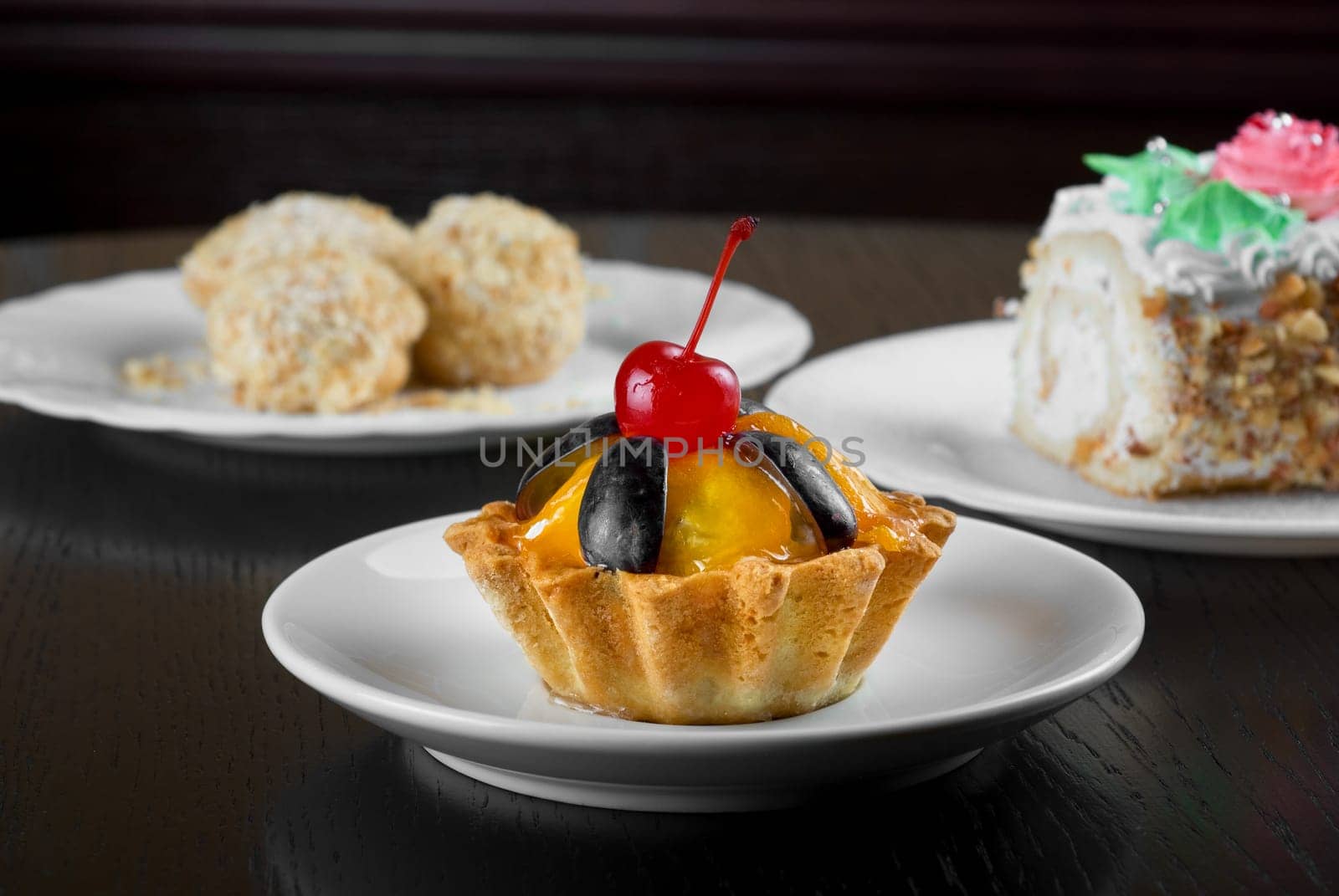 fresh baked cherry cupcake on a wooden table