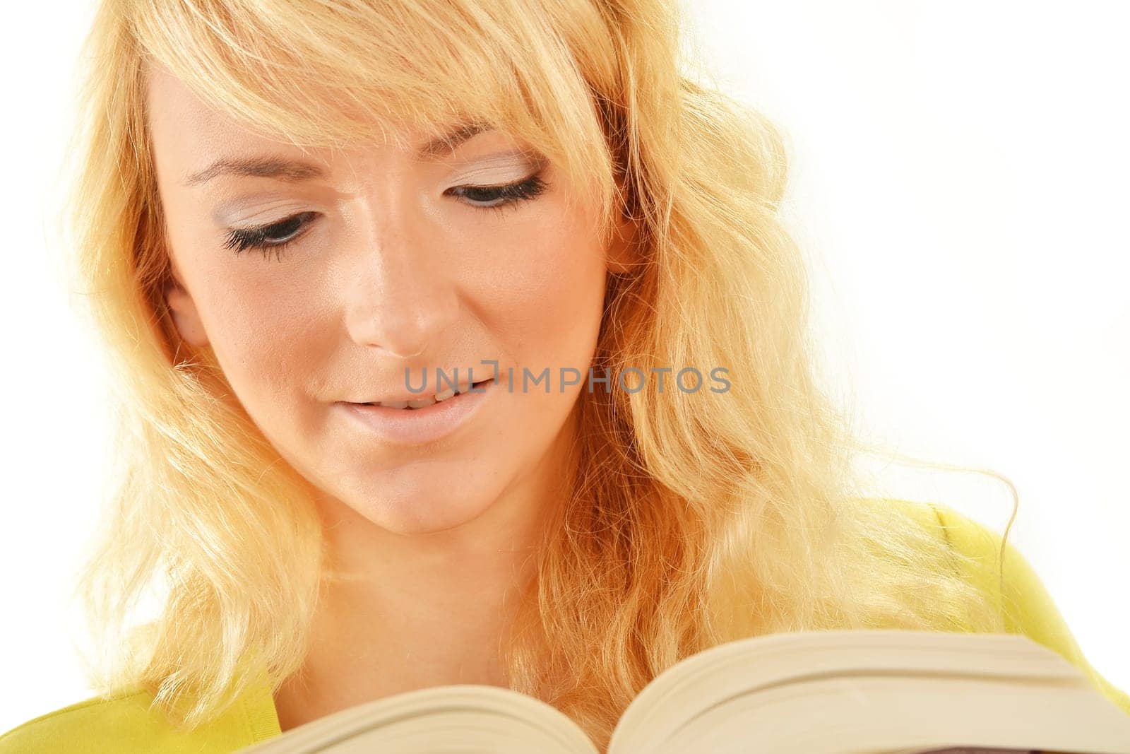 Portrait of young caucasian woman reading a book. Female student studying