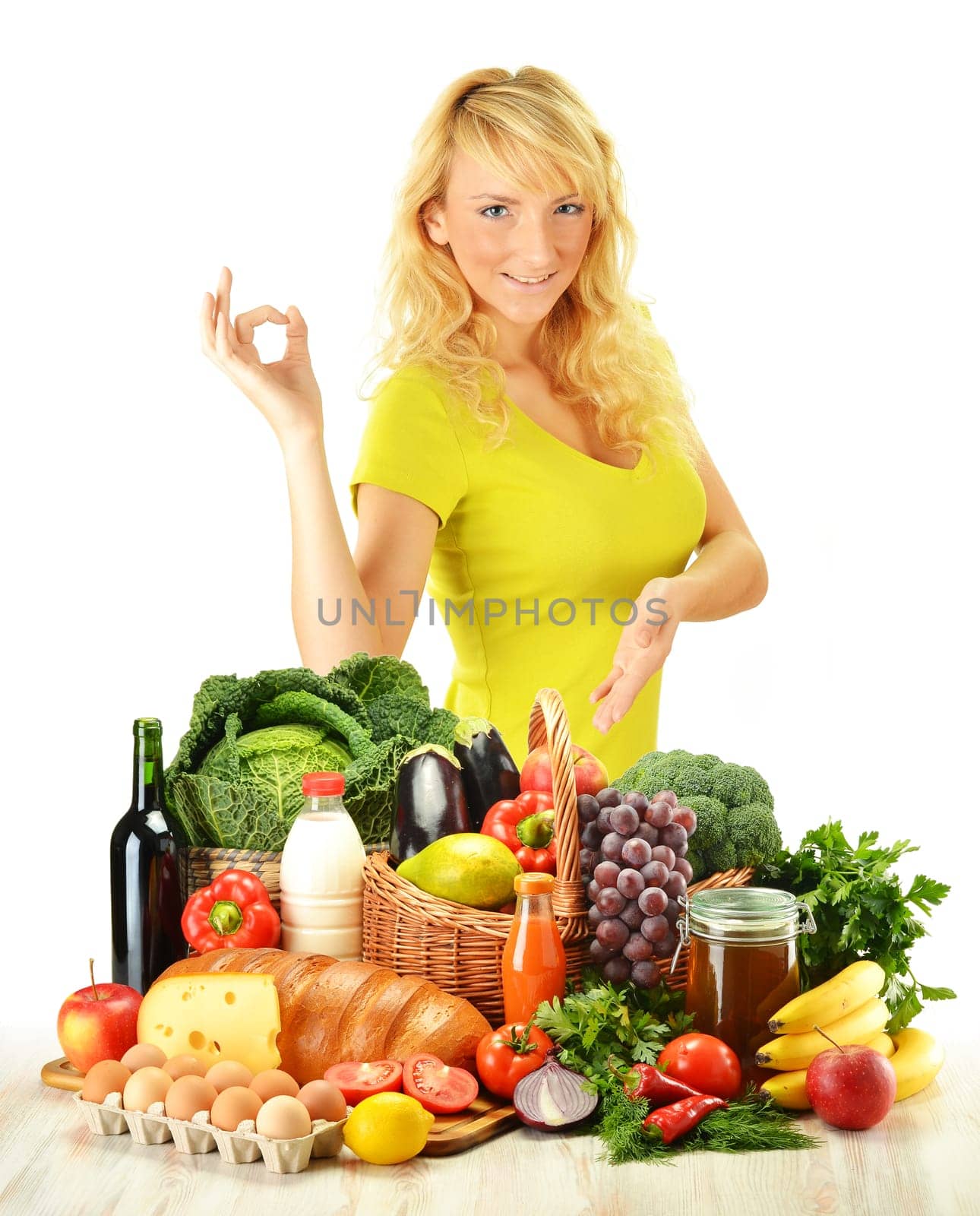 Young woman with groceries isolated on white