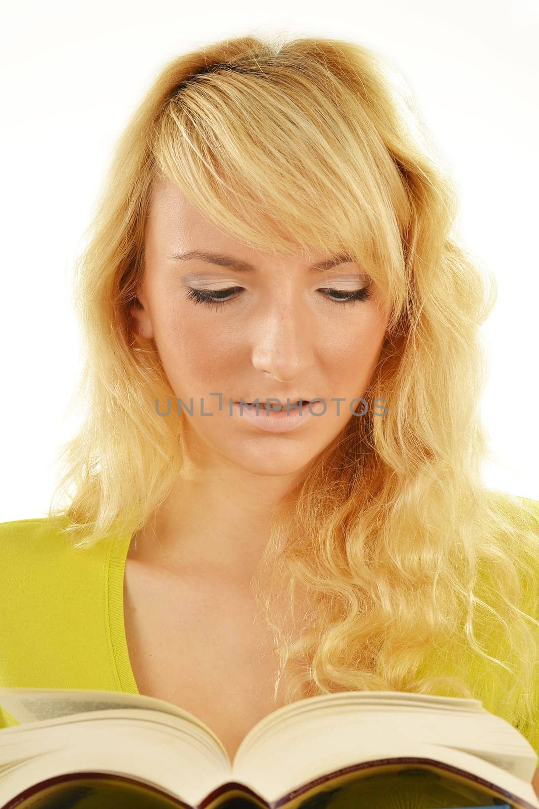 Portrait of young caucasian woman reading a book. Female student studying