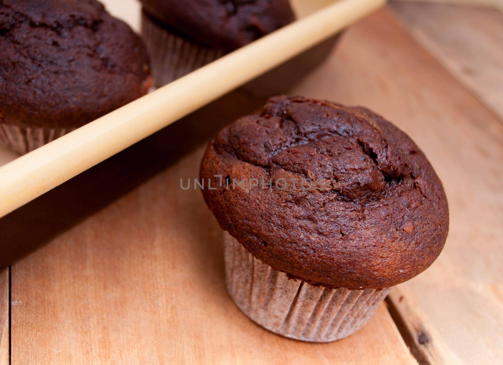 Baking of Muffins - Chocolate Muffin and Cake Tin on Wooden Table