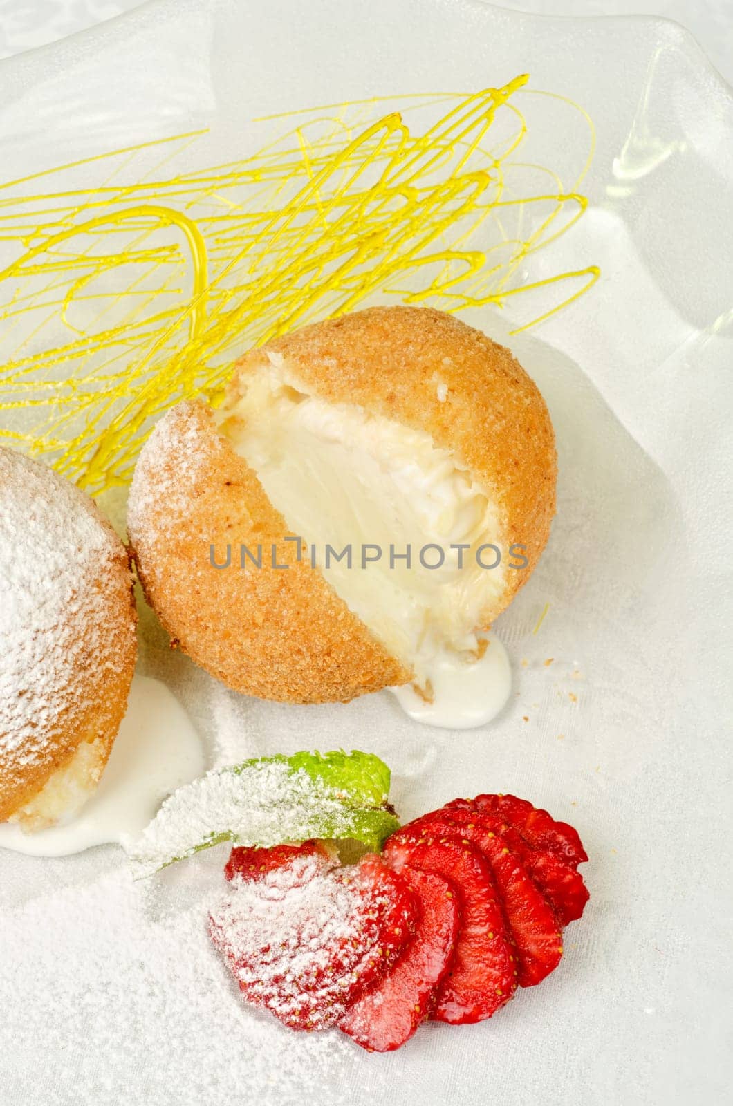 Dessert of ice-cream at biscuit with strawberry and caramel