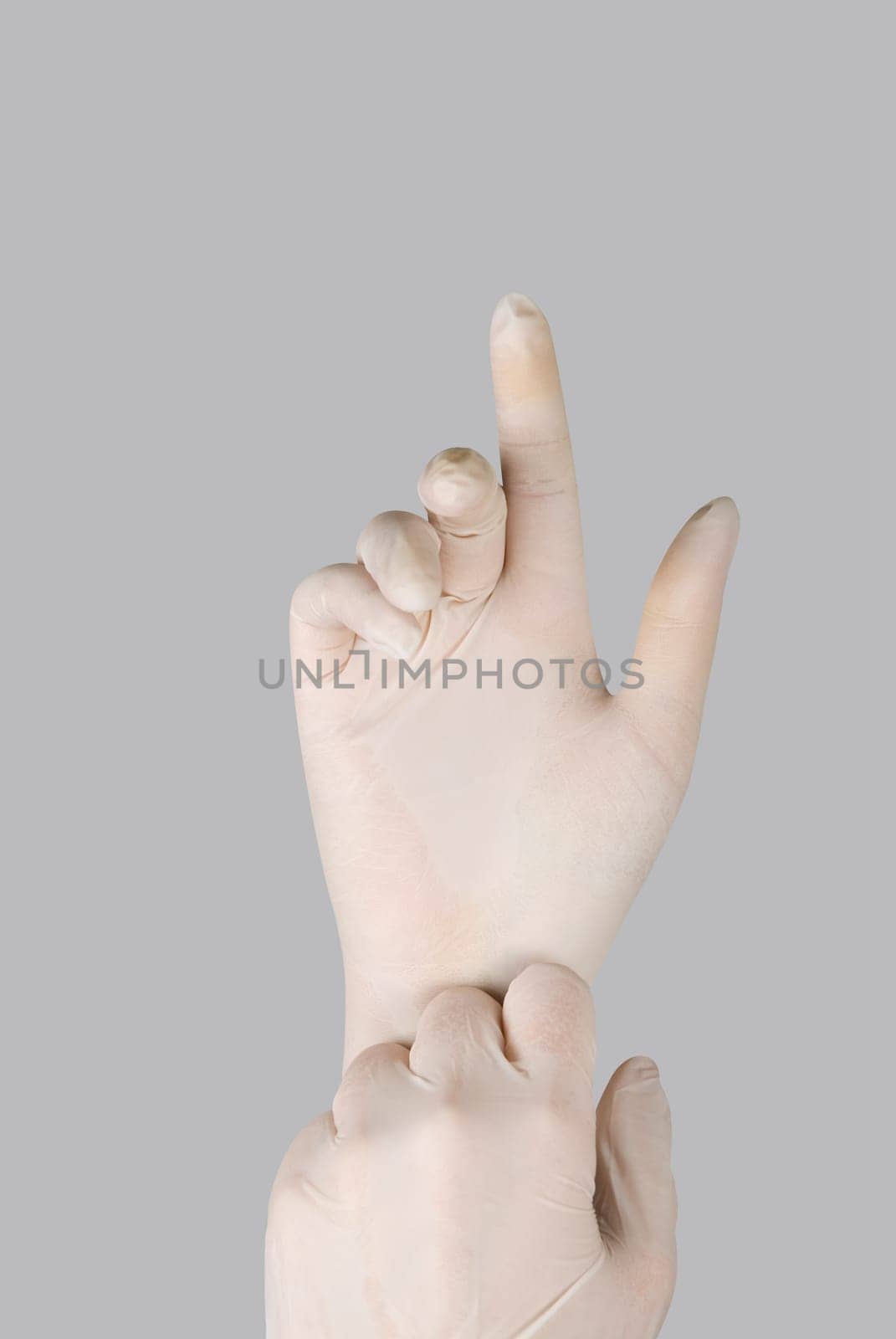 gloves on a hand on a grey background