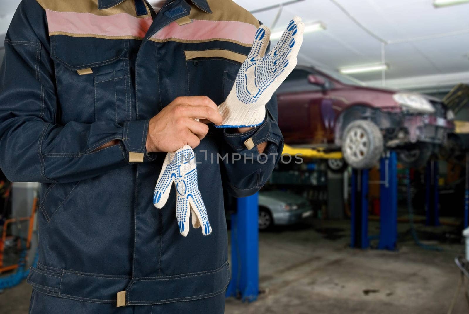Auto mechanics closeup standing in his workshop