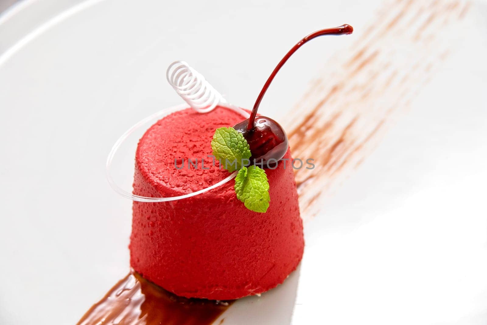 Tasty dessert of whipped cream, chocolate cherry, caramel and mint