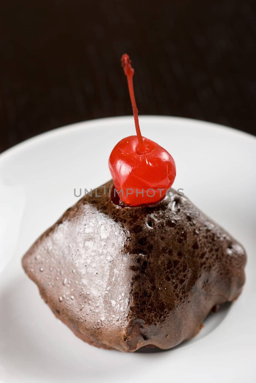 fresh baked cherry cupcake on a wooden table