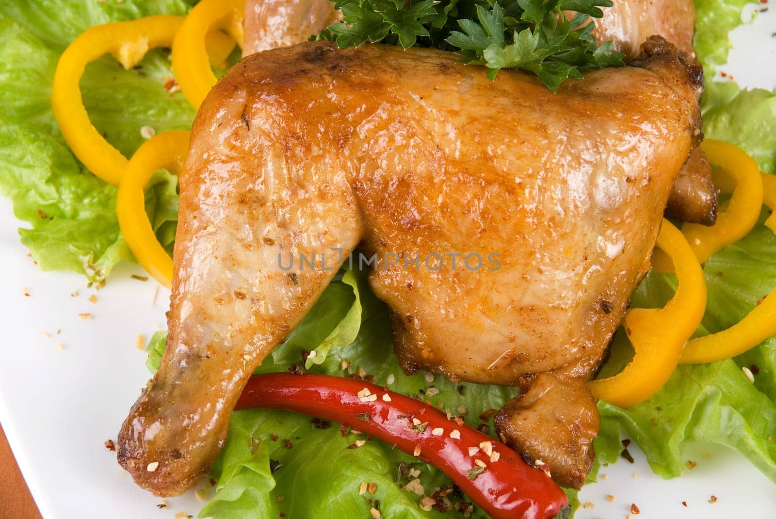 roasted chicken ham garnished with fresh green salad, pepper and greens