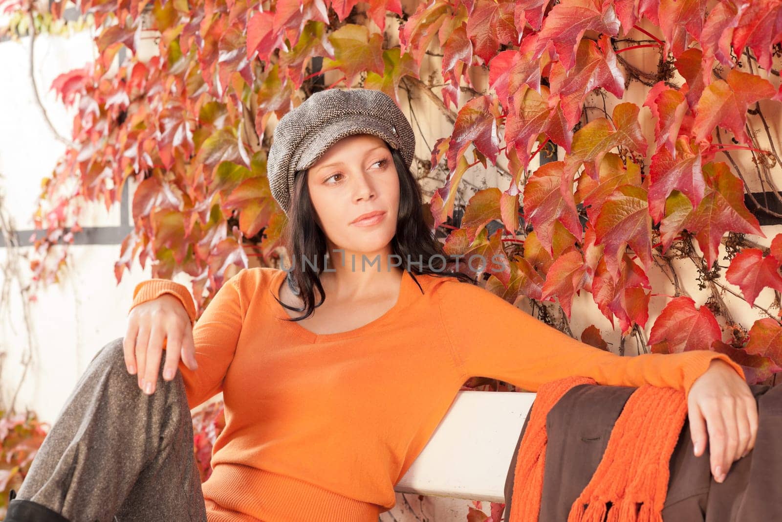Autumn leaves park scenery young woman relax sitting on bench