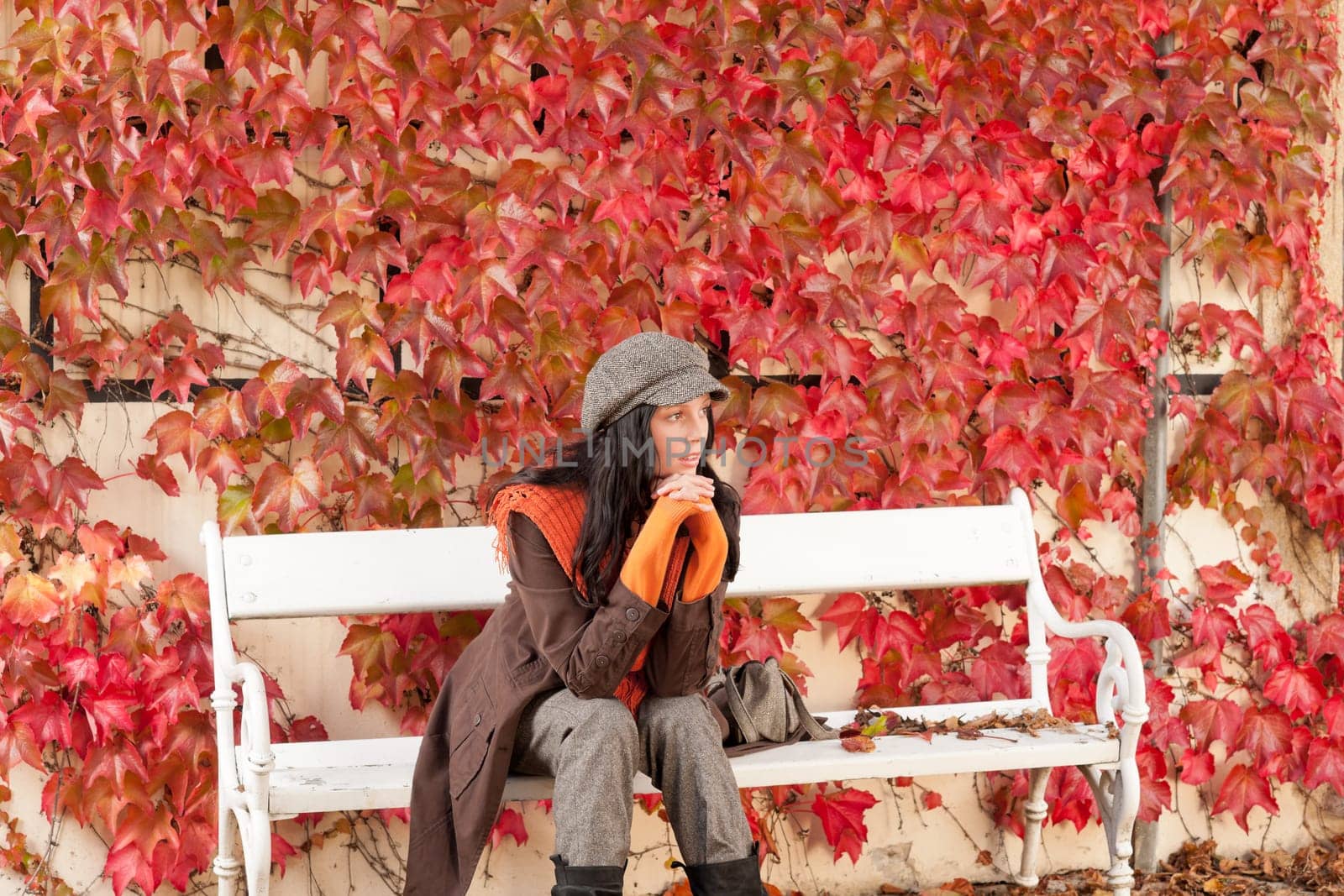 Autumn leaves park scenery young woman relax sitting on bench