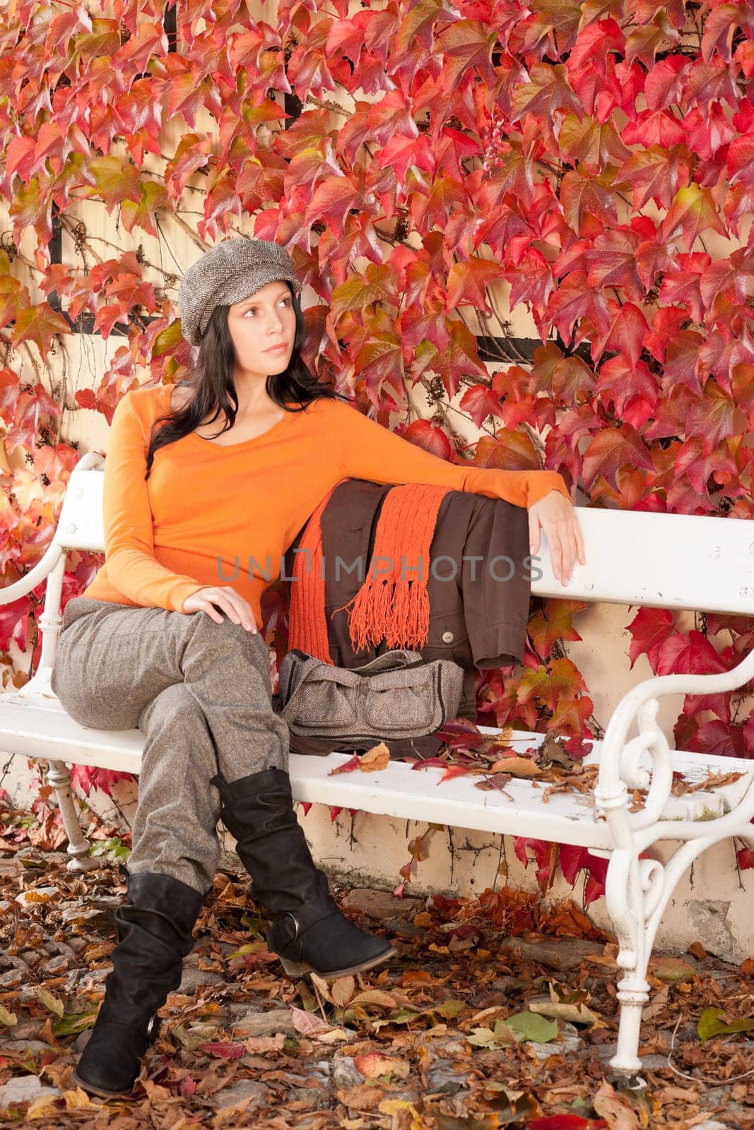 Autumn leaves park scenery young woman relax sitting on bench