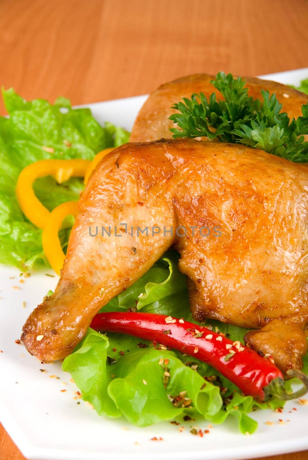 roasted chicken ham garnished with fresh green salad, pepper and greens