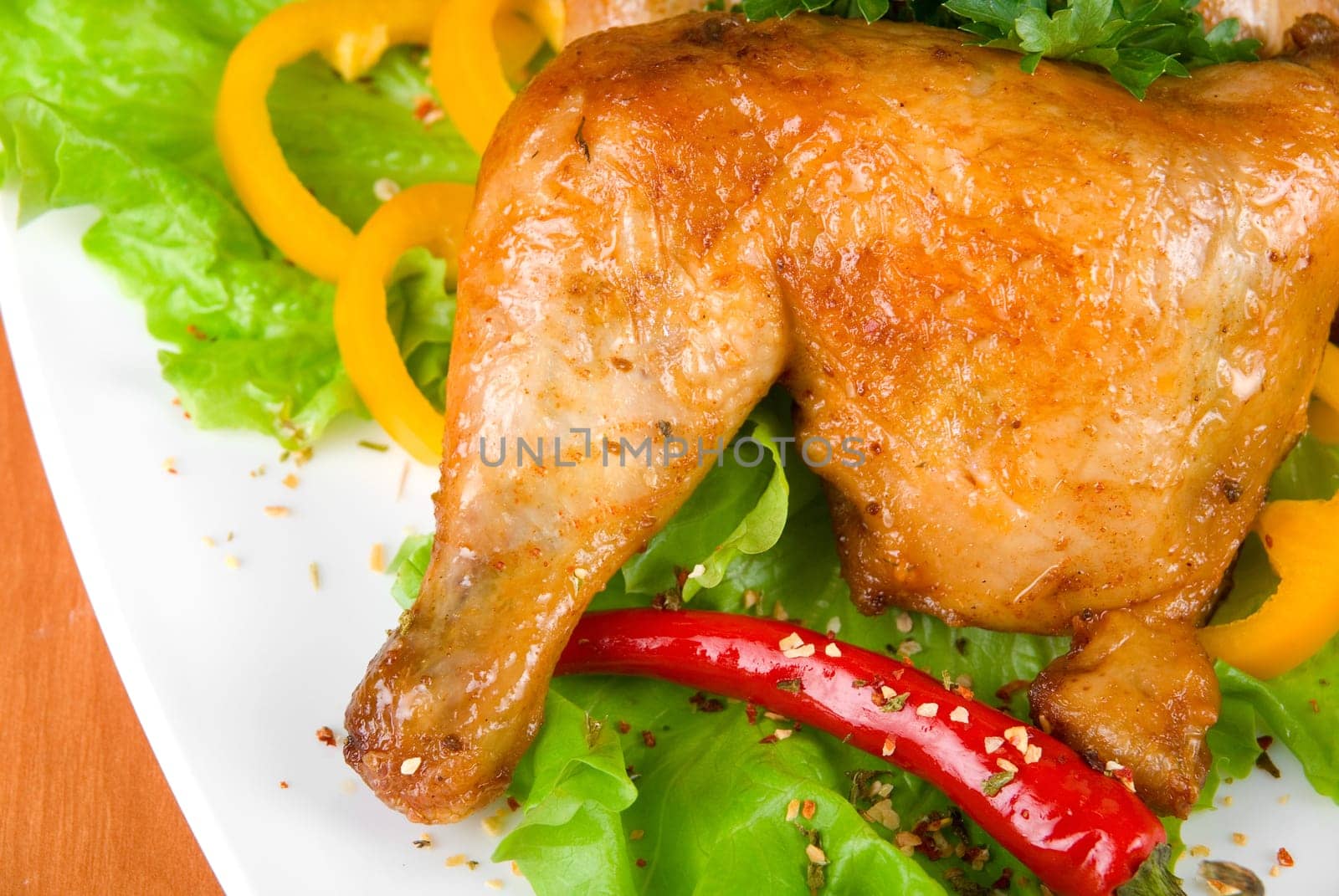 roasted chicken ham garnished with fresh green salad, pepper and greens