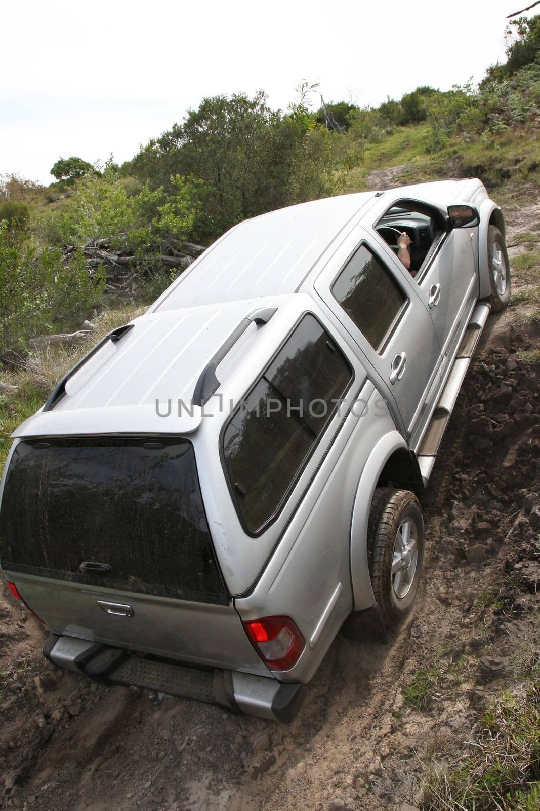 An offroad 4x4 vehicle negotiang a steep climb