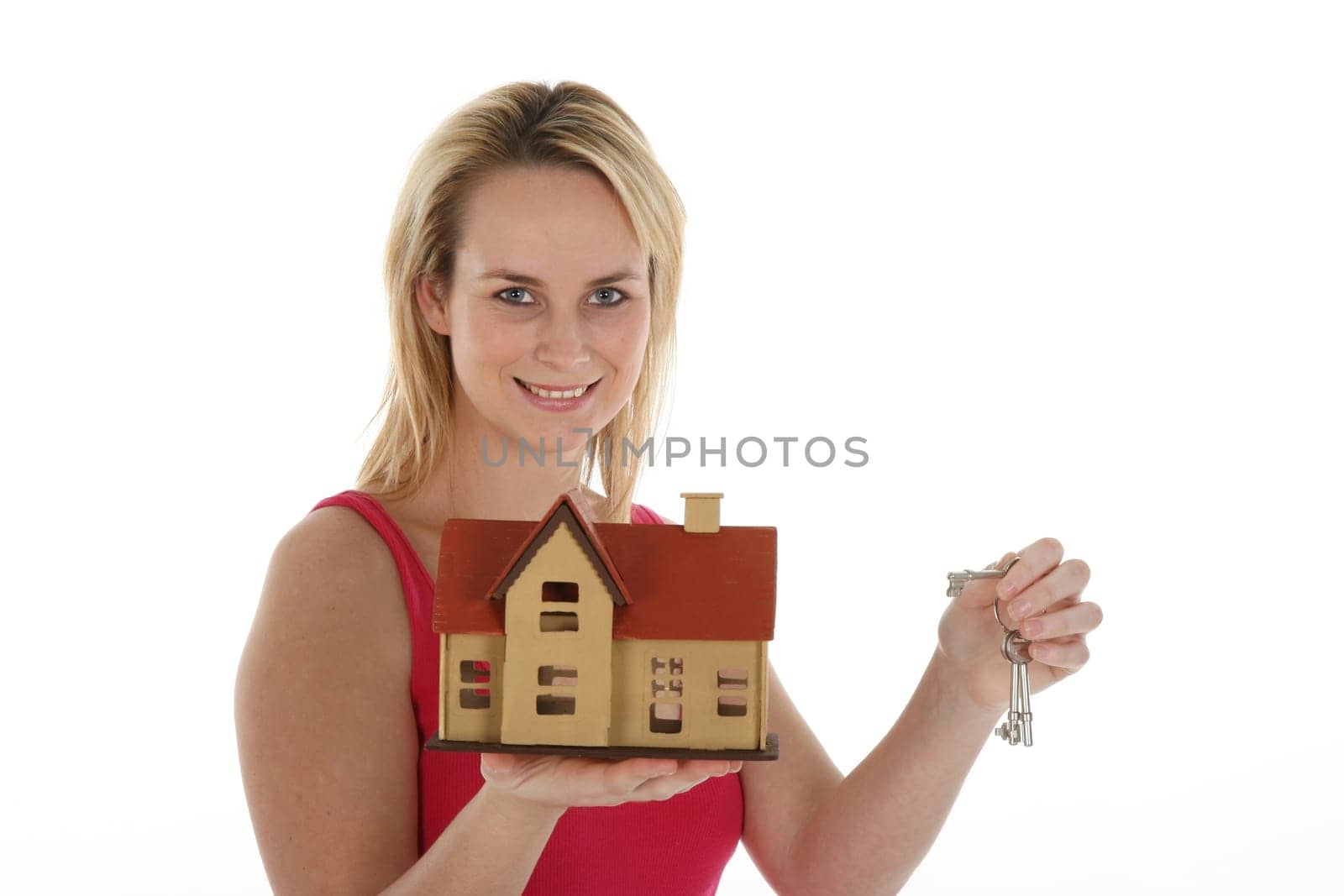 Lovely estate agent woman with keys and conceptual house for sale