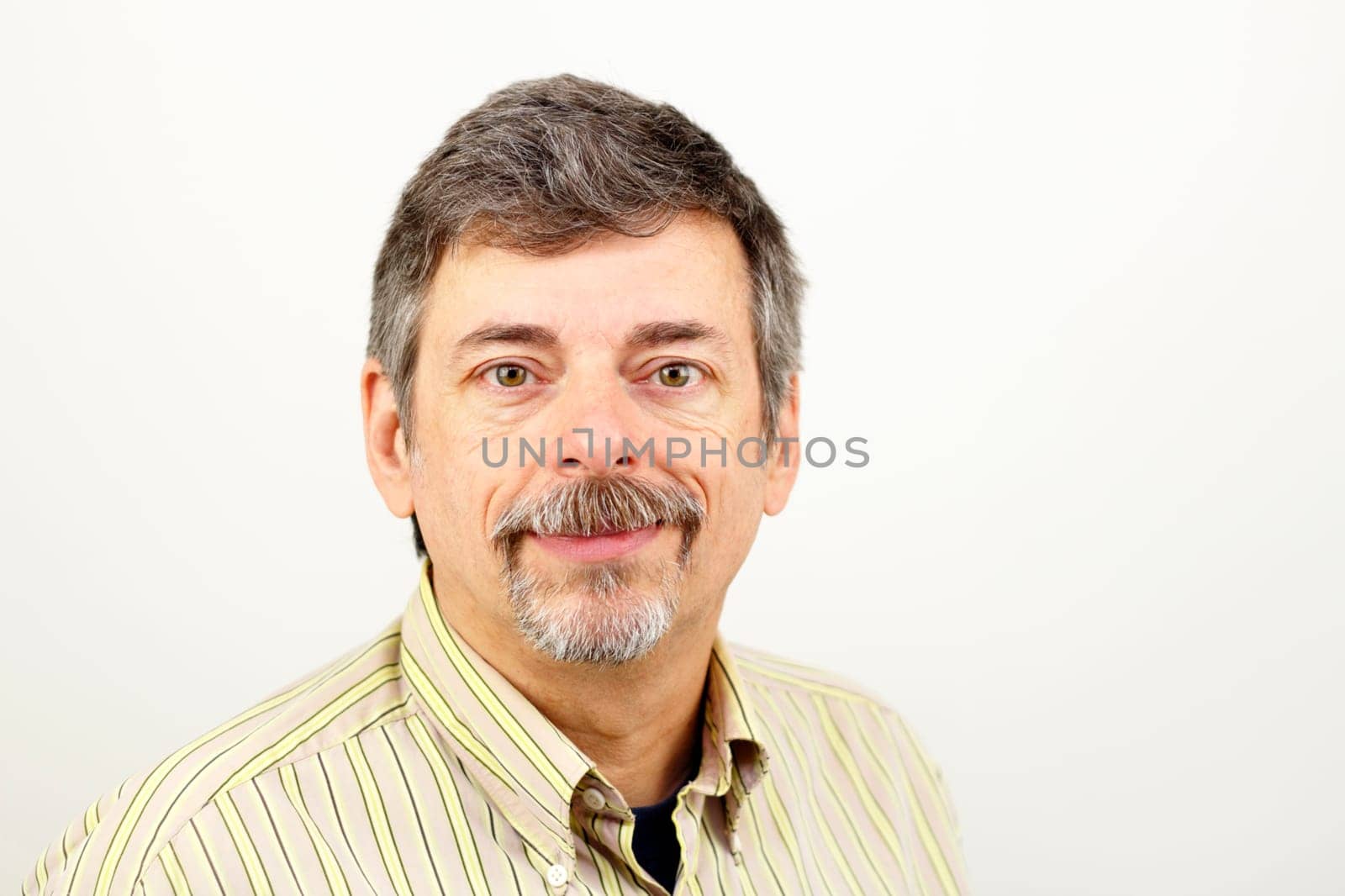 Relaxed, happy man looking towards viewer.