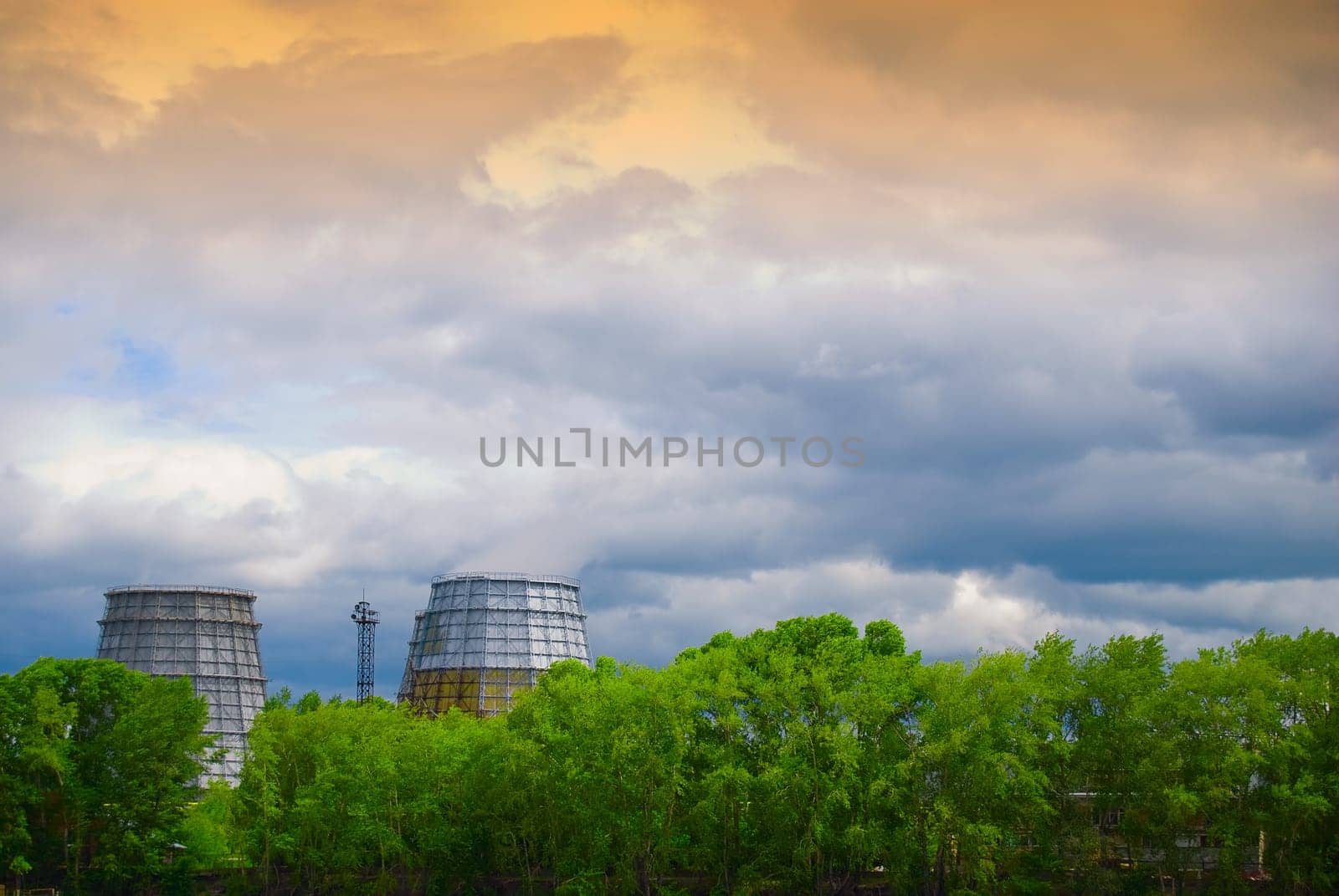 Two huge industrial pipes of the plant are smoking and polluting environment