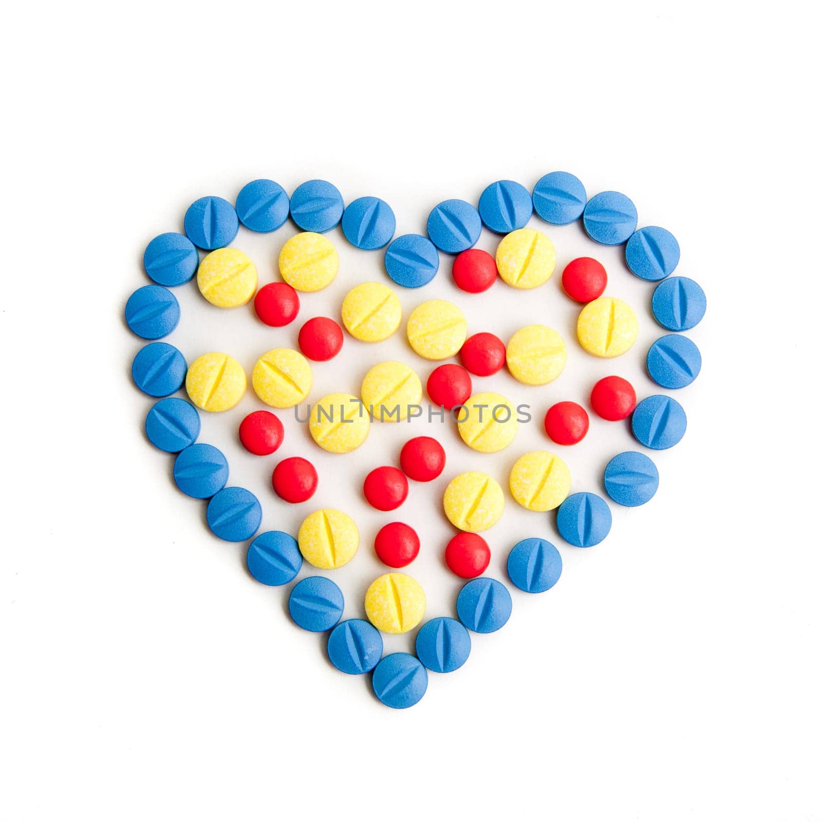 Medical concept created by pills . Isolated on white