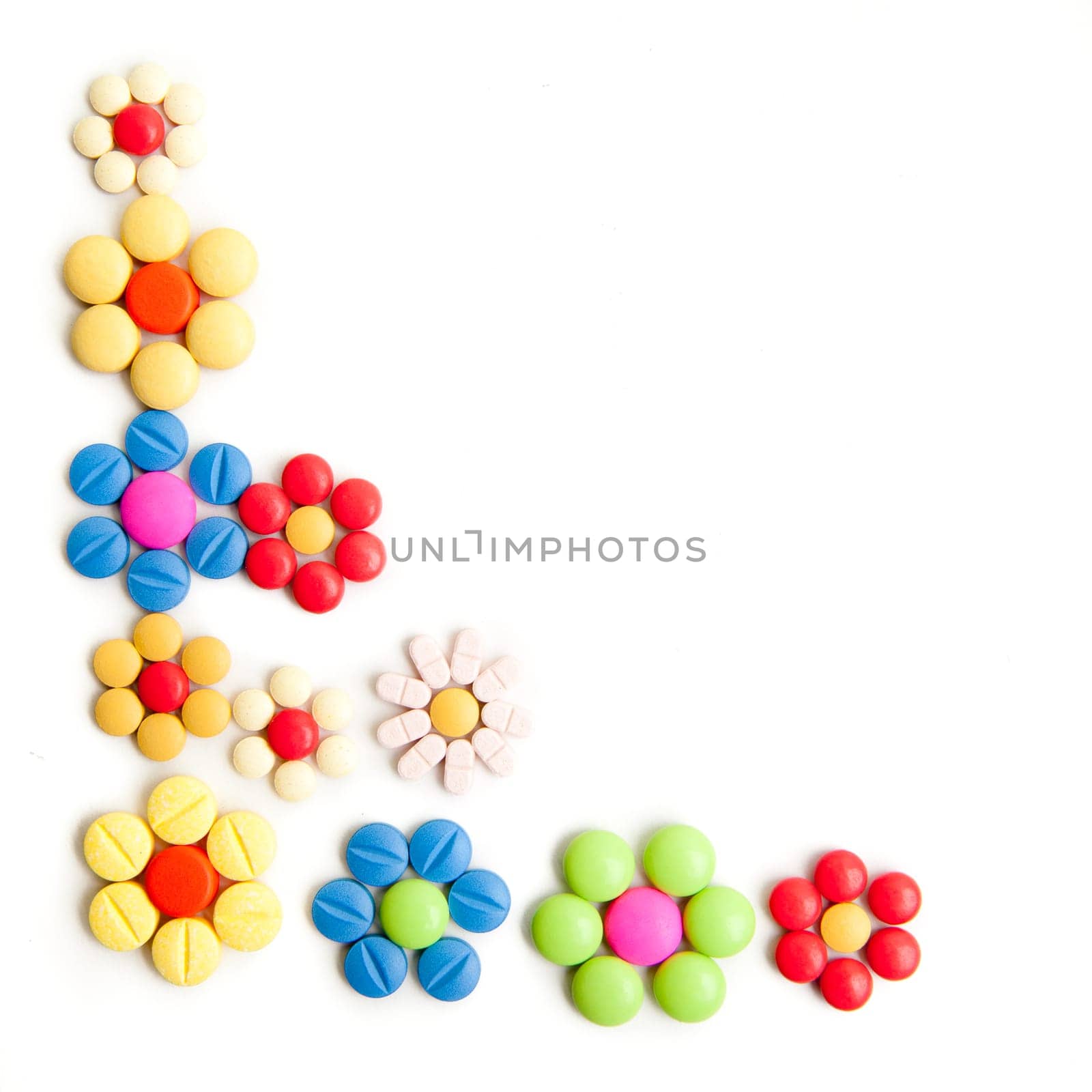 Medical concept created by pills . Isolated on white