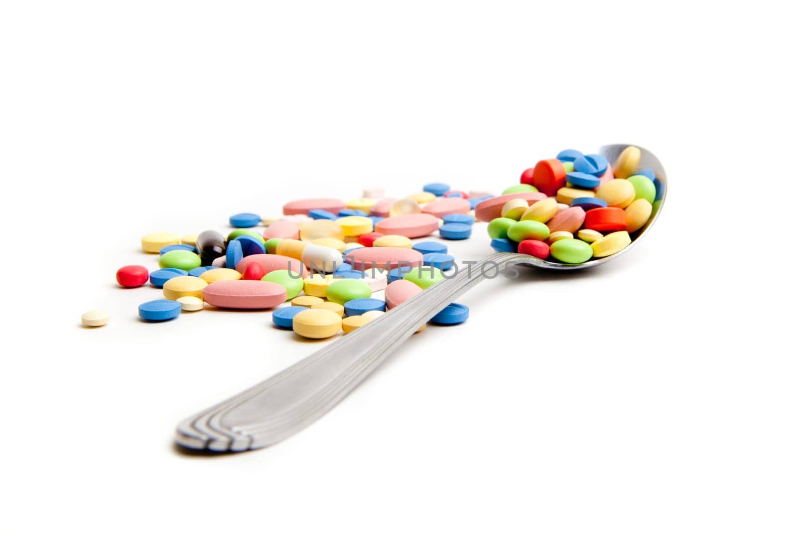 Medical concept created by pills . Isolated on white