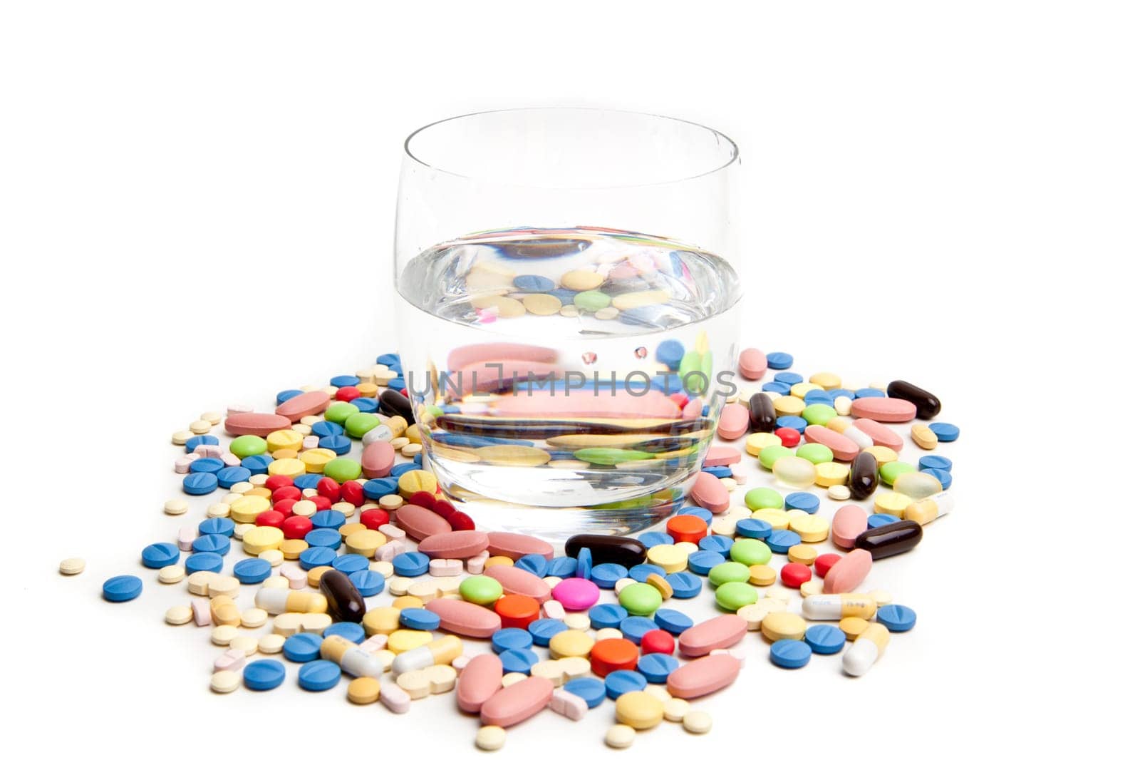Medical concept created by pills . Isolated on white