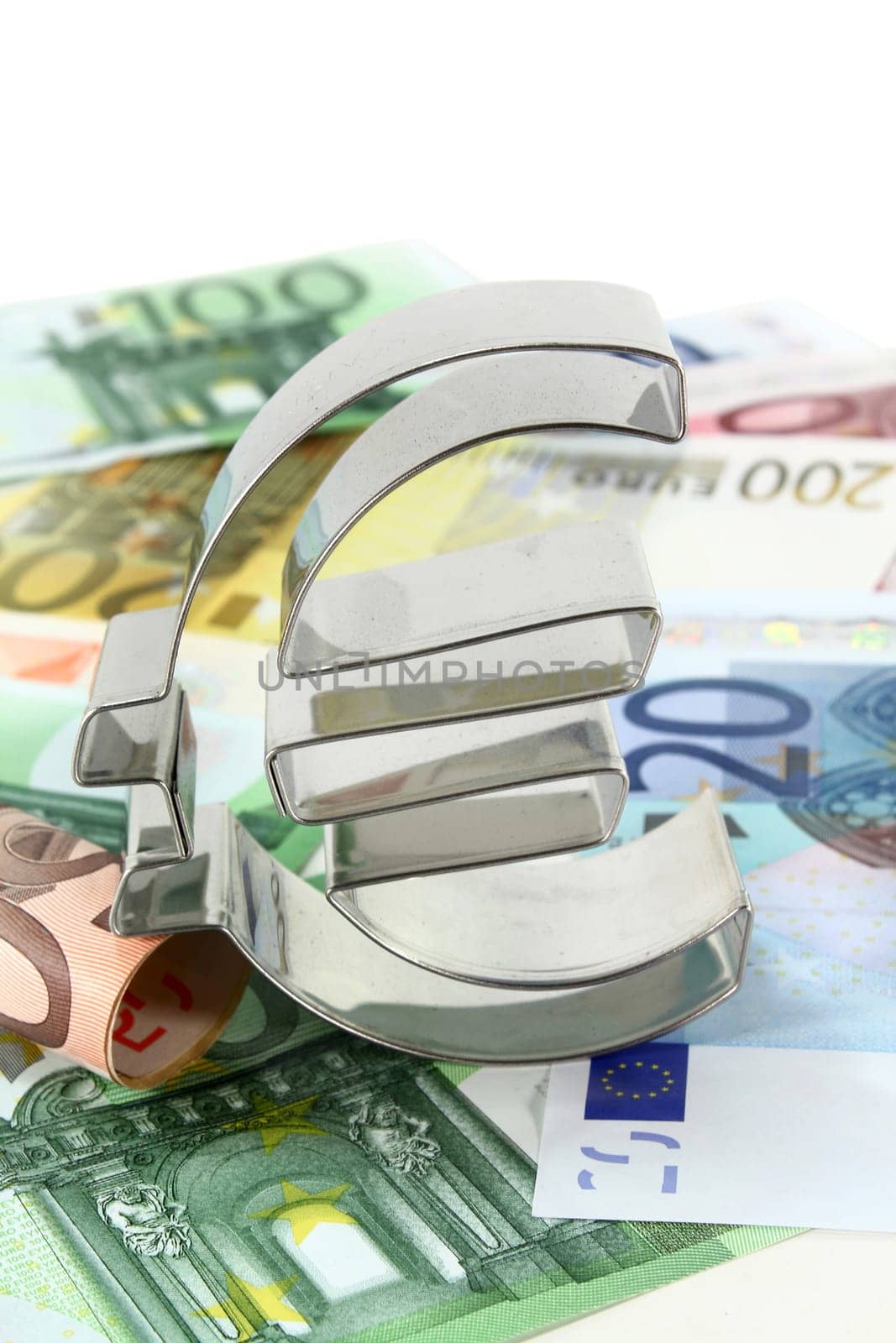Euro bills and euro signs against white background