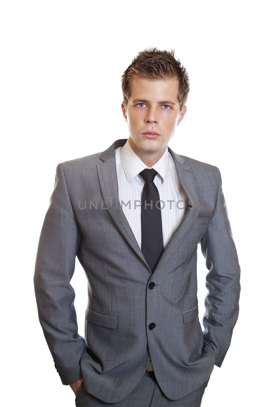 Young successful businessman with hands in pockets