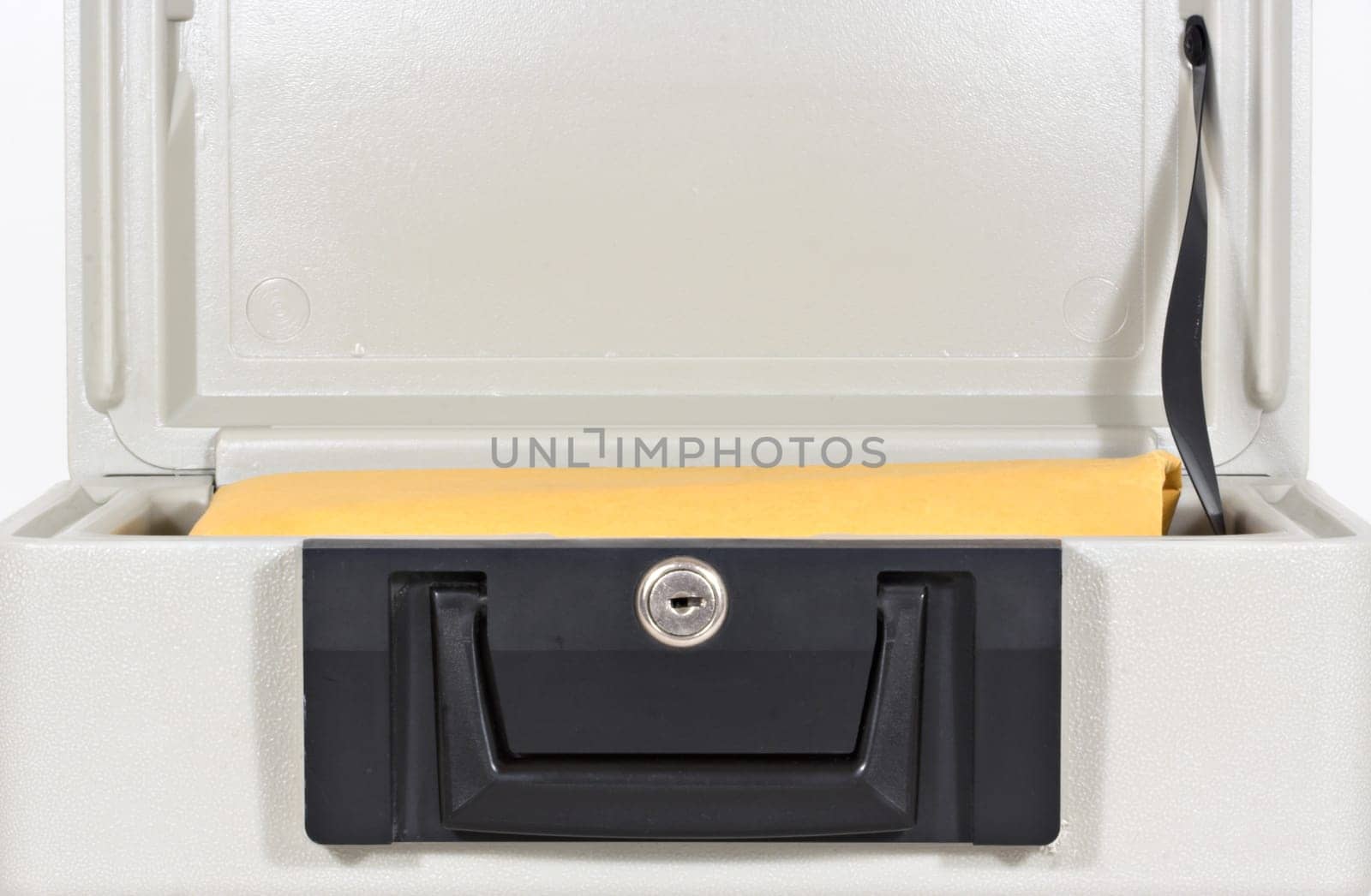 An open fire proof box with a large yellow envelope inside
