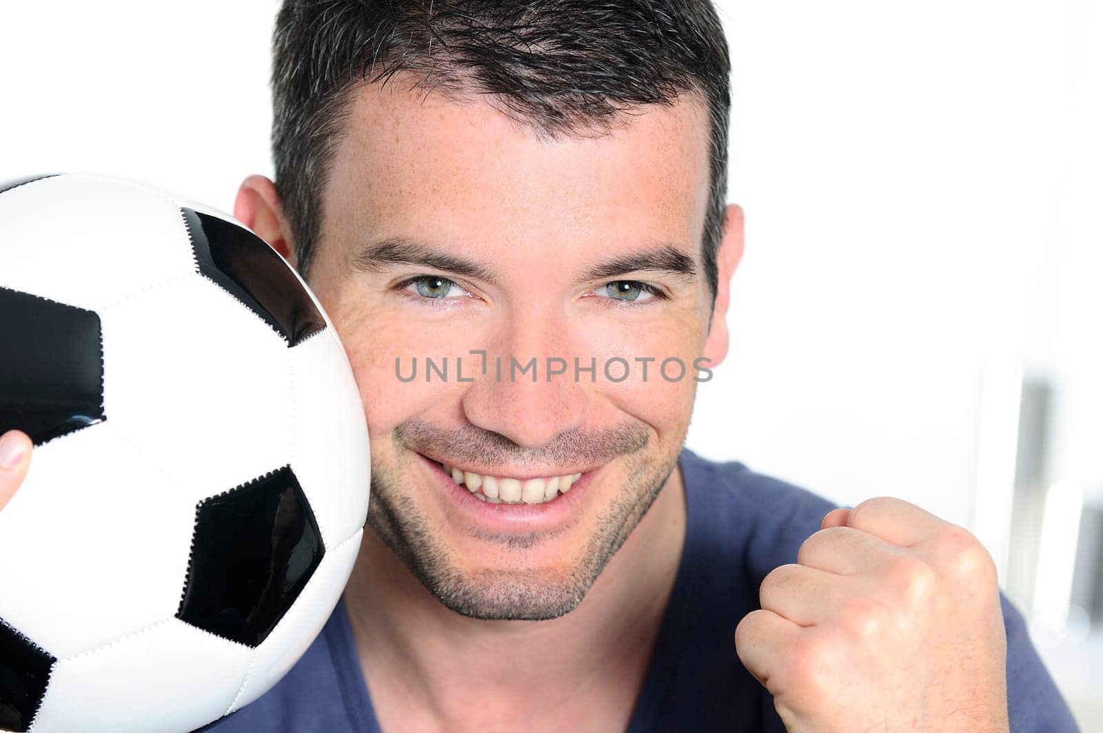 closeup of passionate soccer player with white and black balloon