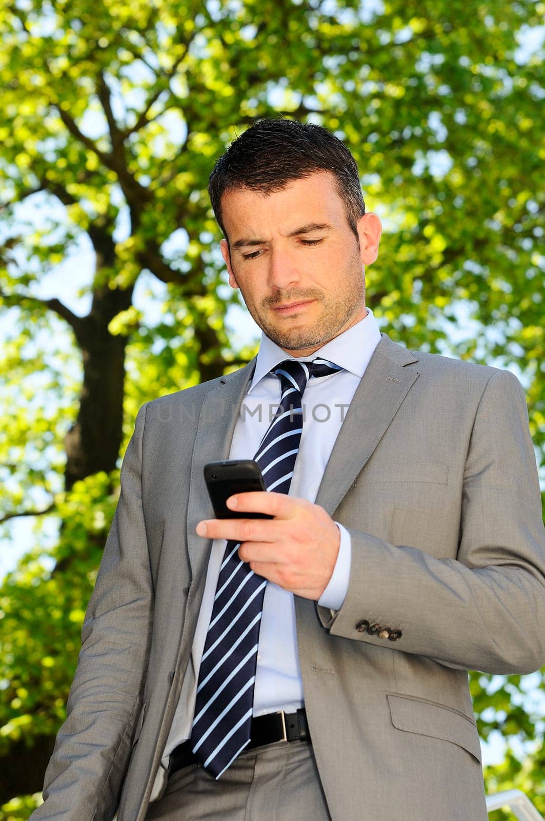 attractive businessman is calling by phone