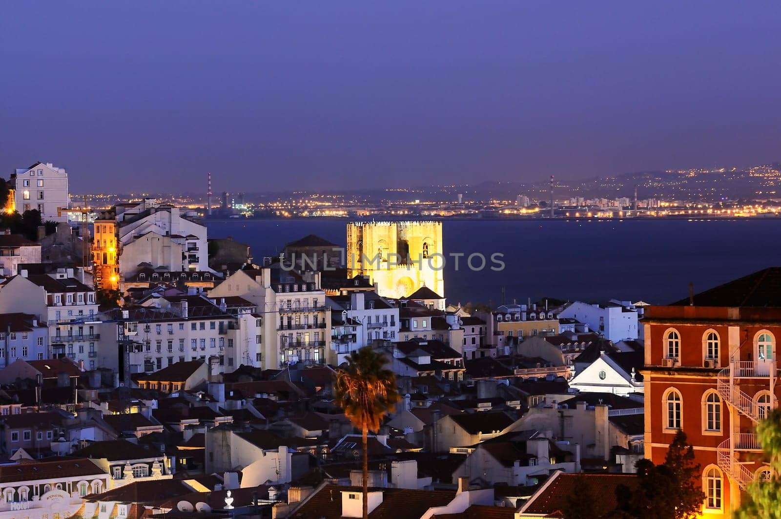 Historic mediterranean architecture with church at night with light in Lisboa, Portugal