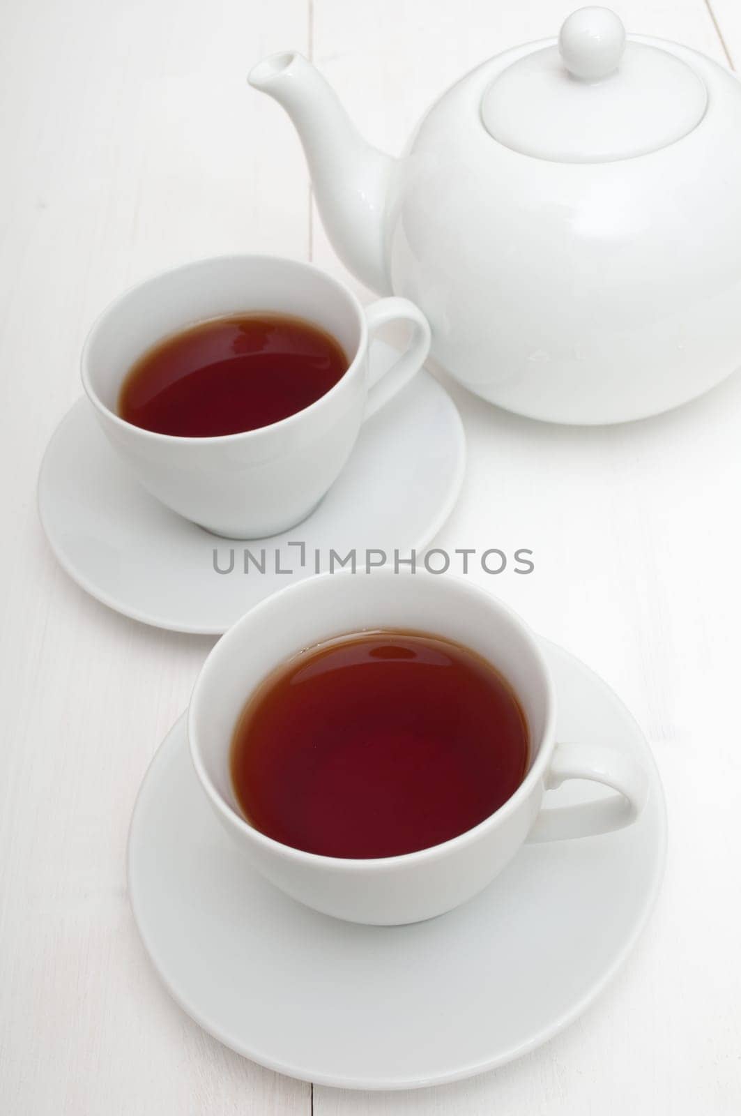 White Cups of Tea and Teapot on White Table