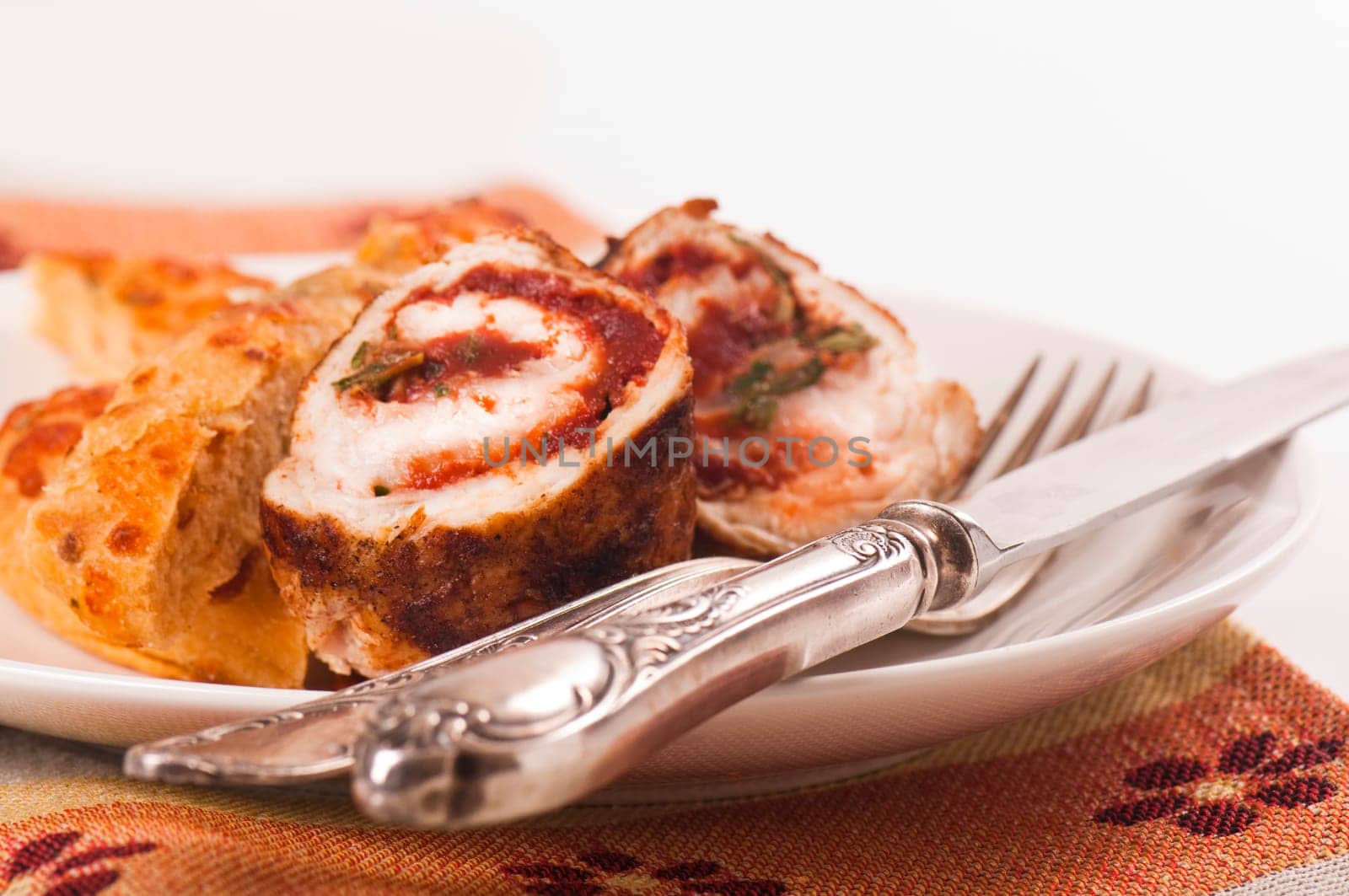 Schnitzel roll on porcelain plate with white bread