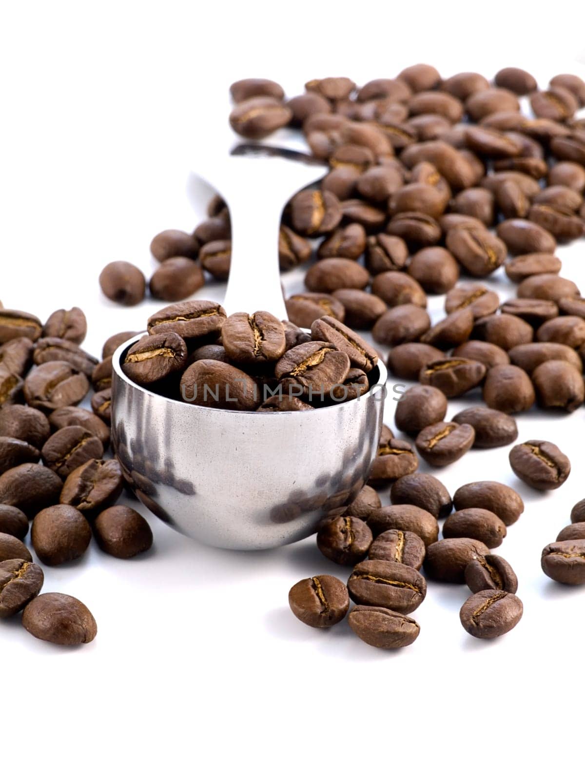spoon full of coffee beans isolated on white background