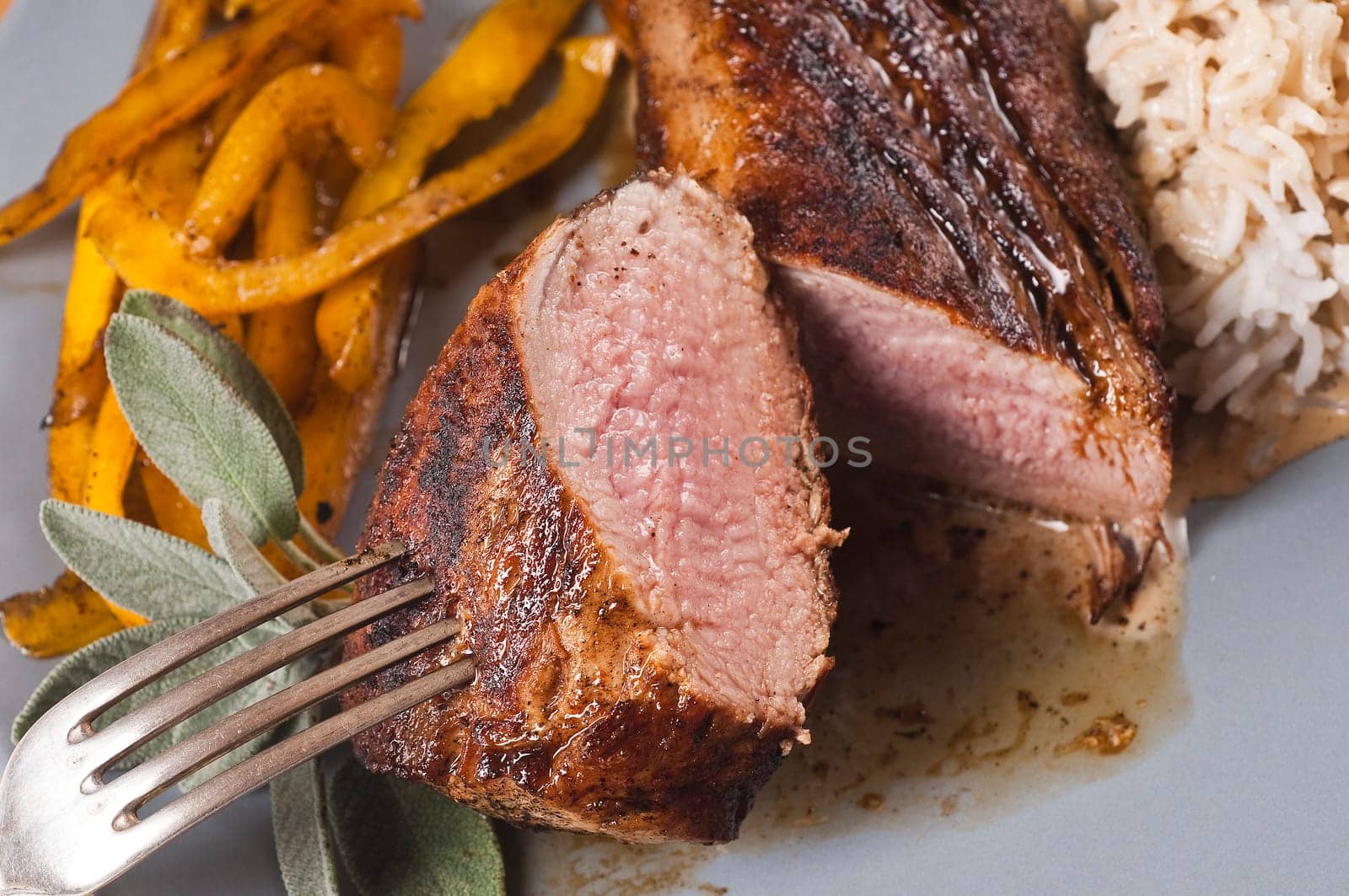 roasted pork tenderloin on grey plate