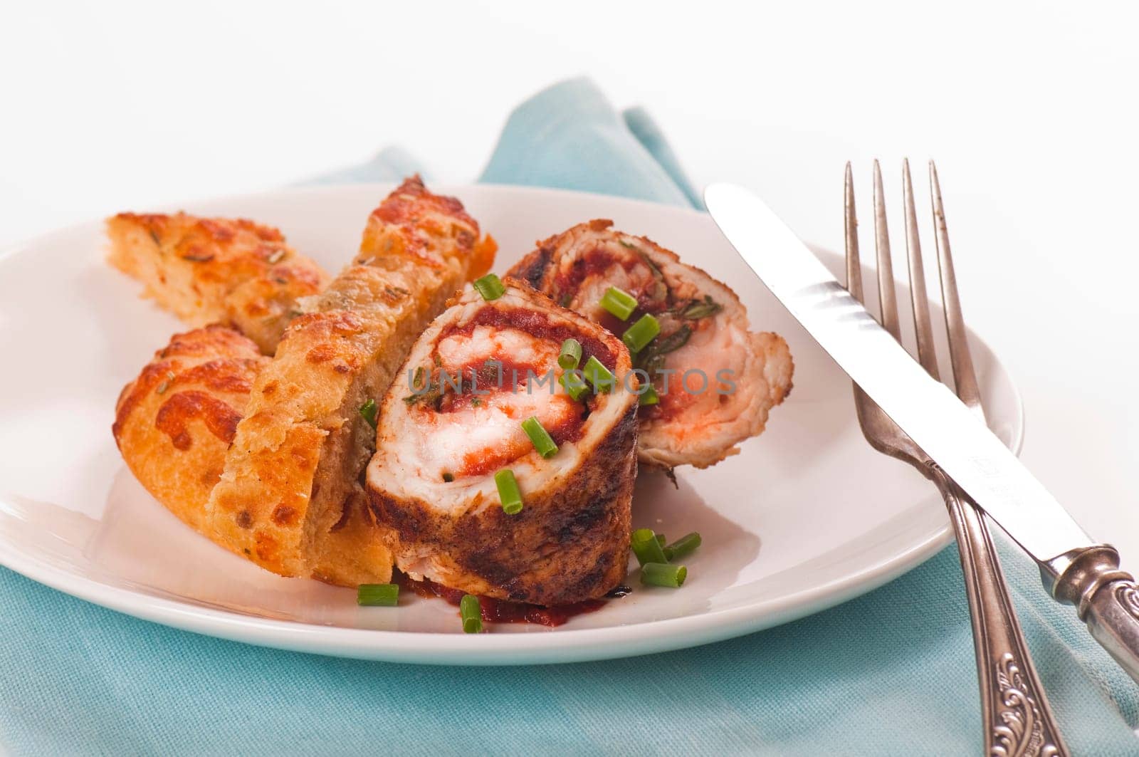Schnitzel roll on porcelain plate with white bread