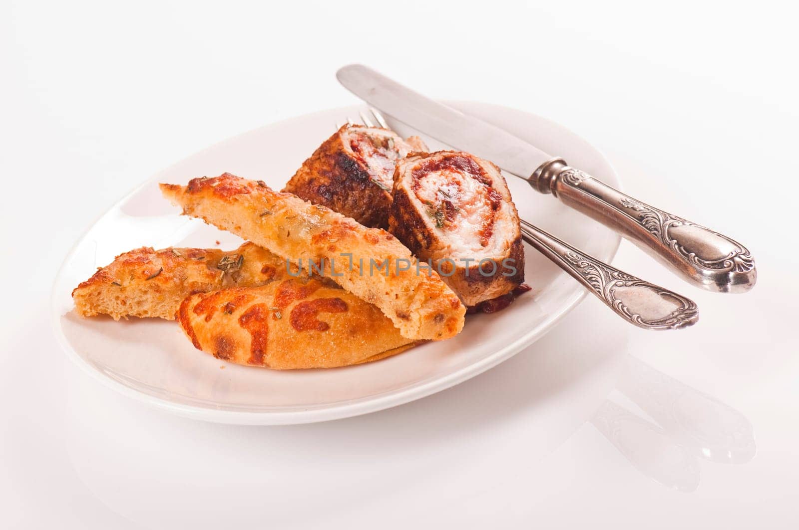 Schnitzel roll on porcelain plate with white bread