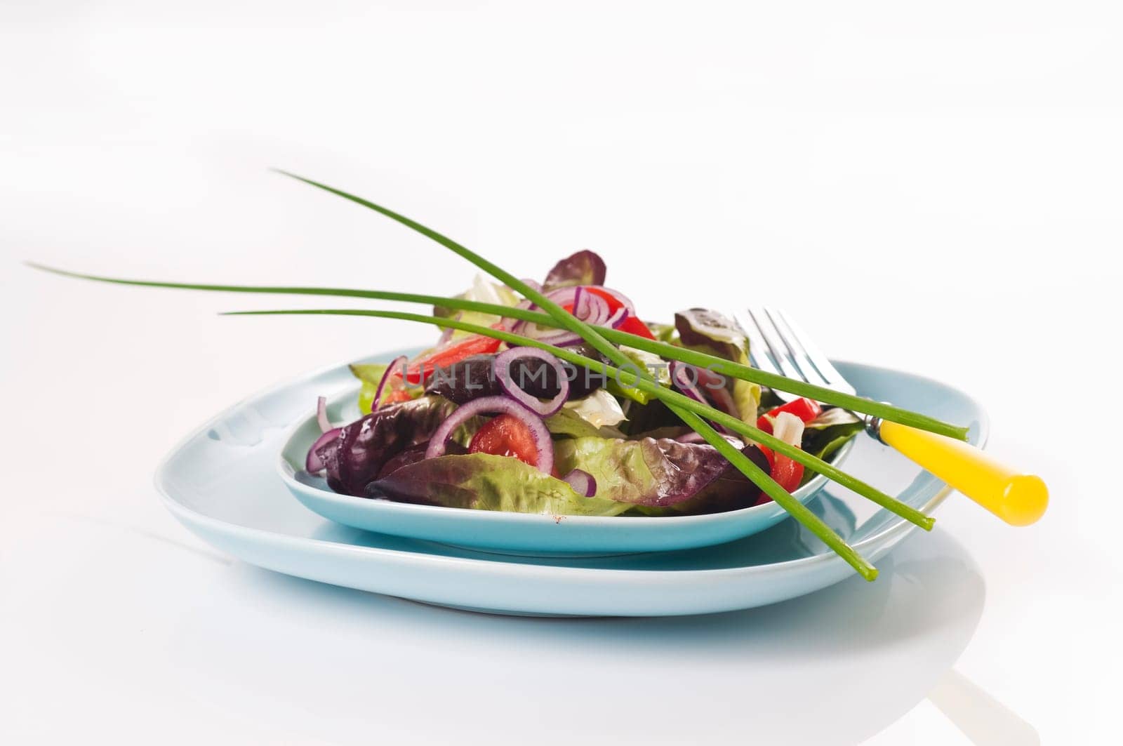 Mixed salad on a light blue plate