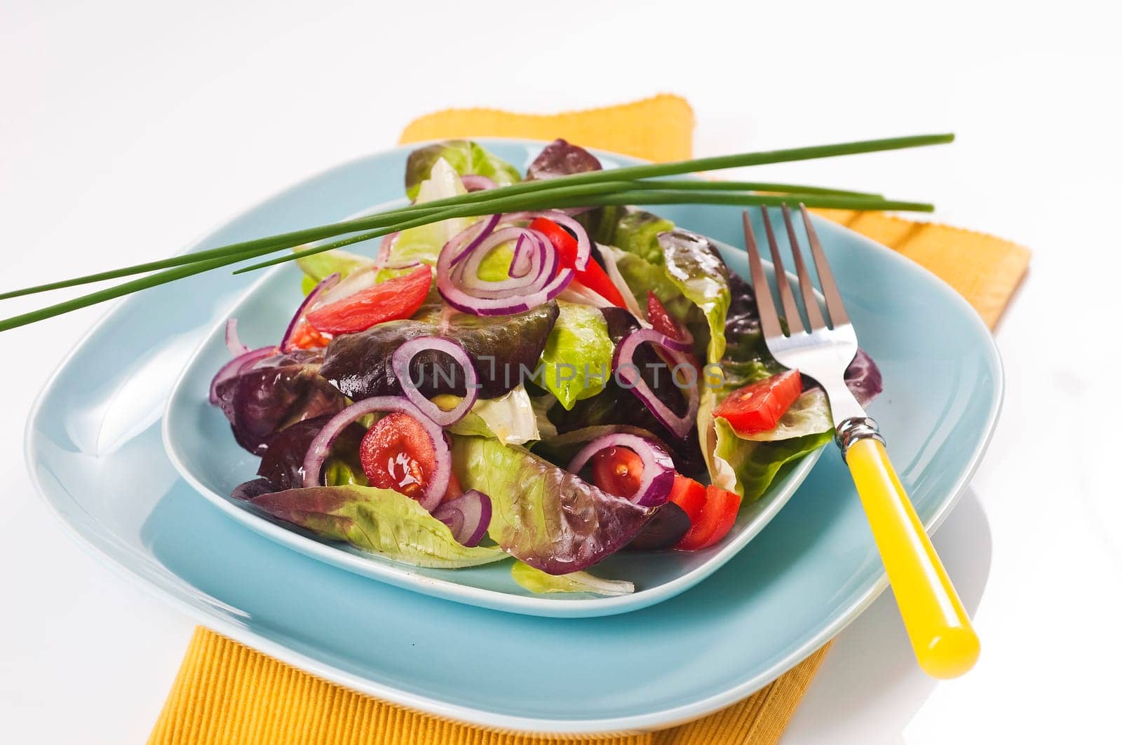 Mixed salad on a light blue plate
