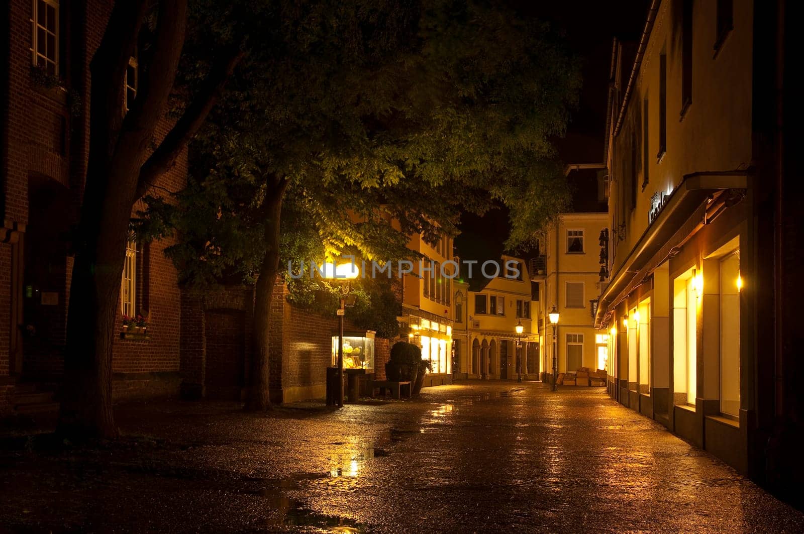 Old town Kempen at night with rain-soaked pavement