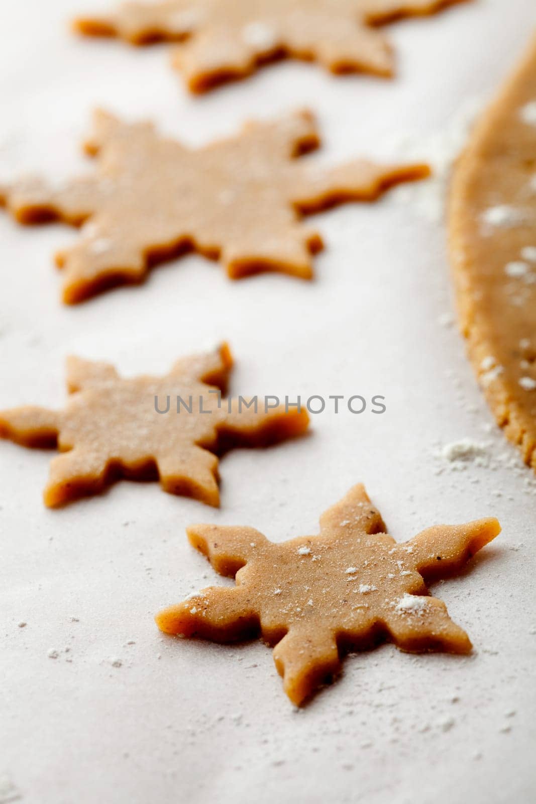 Making gingerbread cookies for Christmas. Gingerbread dough with star shapes.
