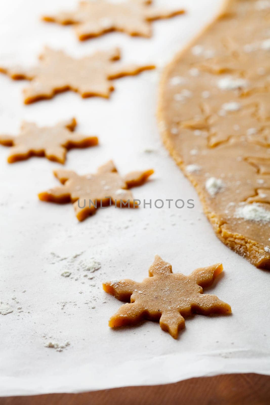 Making gingerbread cookies for Christmas. Gingerbread dough with star shapes.