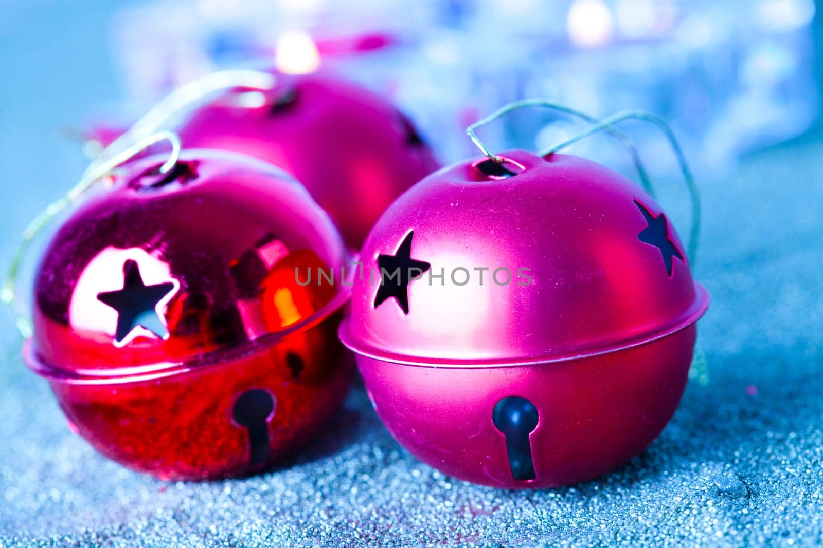 Close-up of jingle bell Christmas baubles with candles