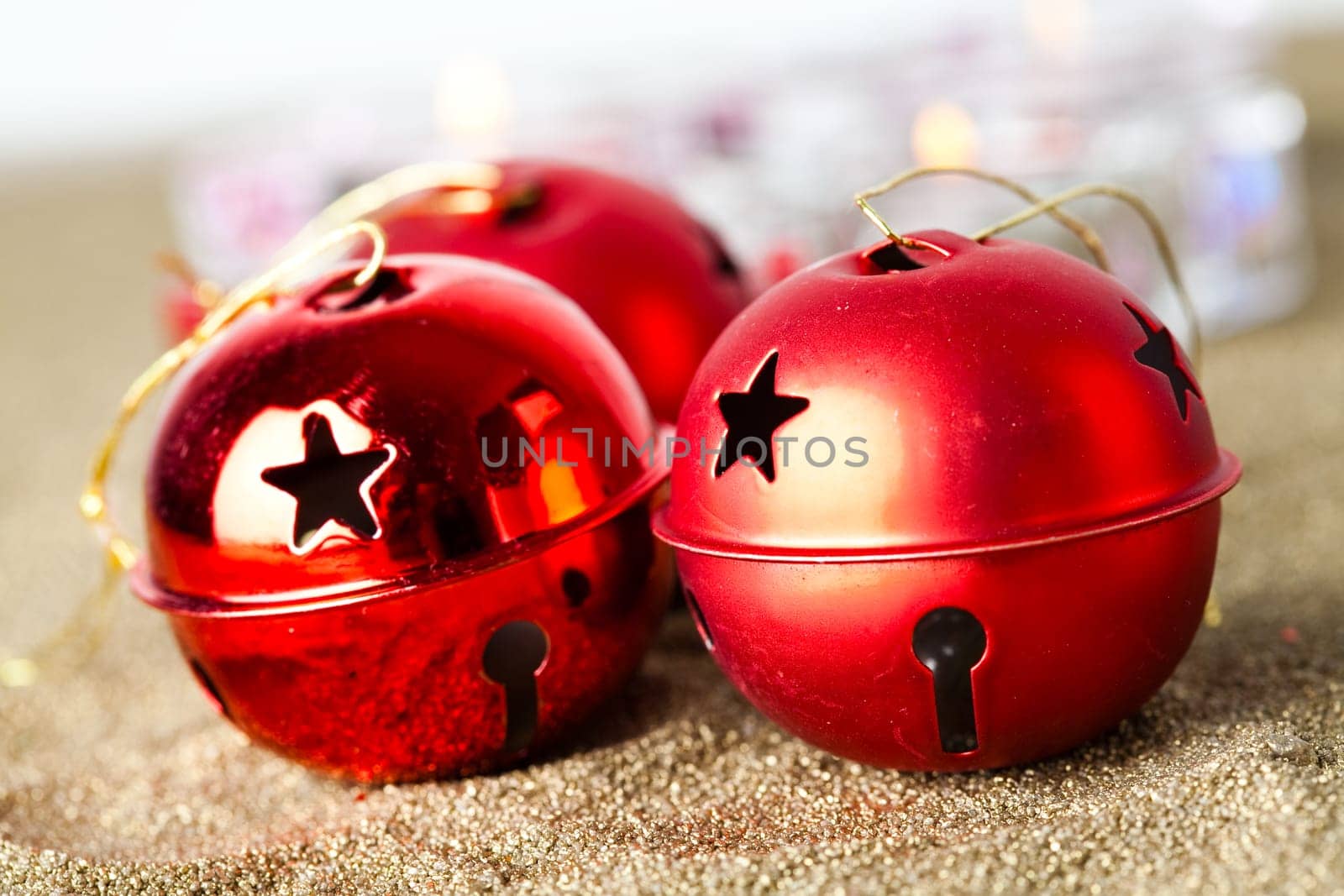 Close-up of jingle bell Christmas baubles with candles