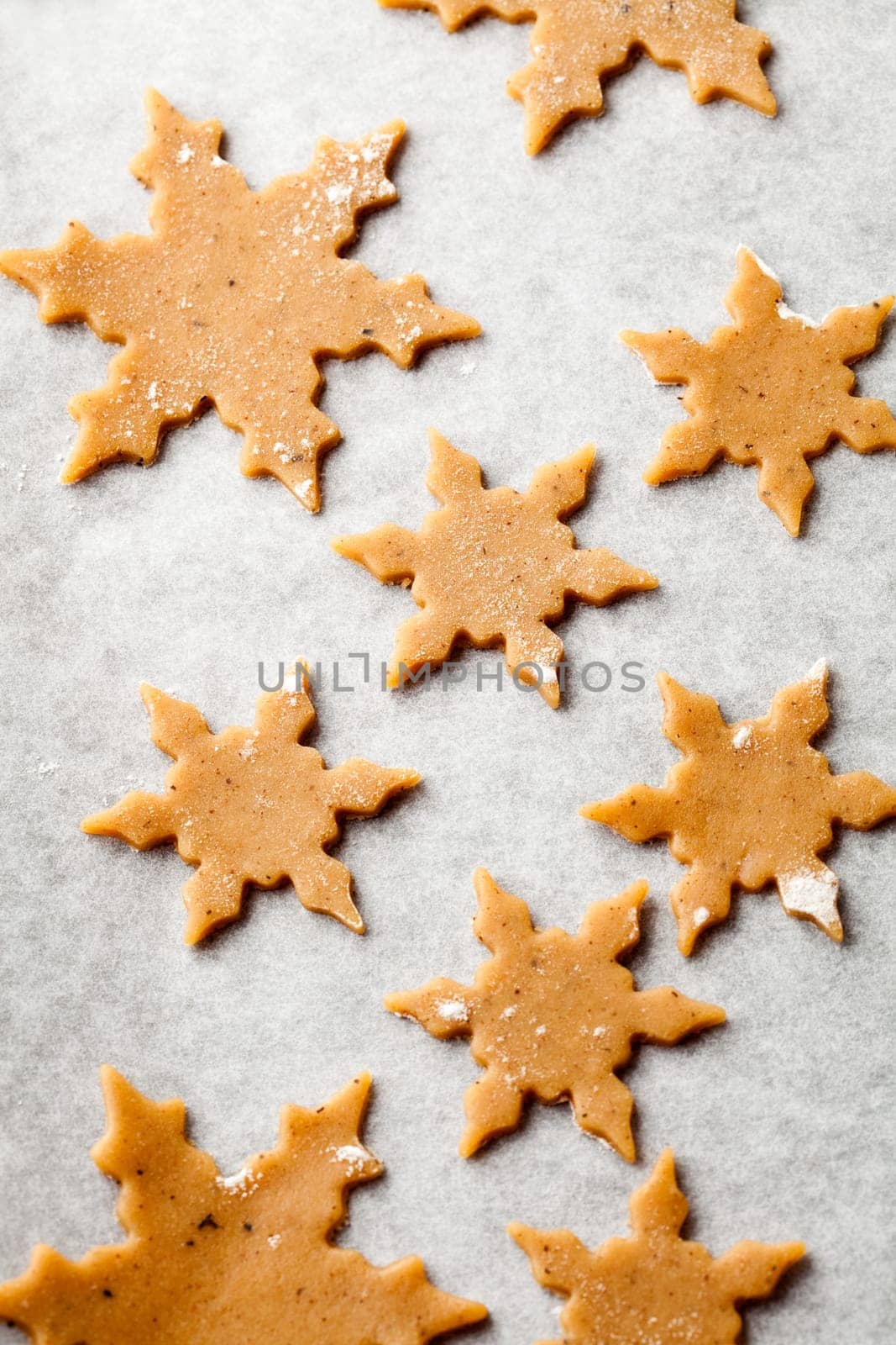 Making gingerbread cookies for Christmas. Gingerbread dough with star shapes.
