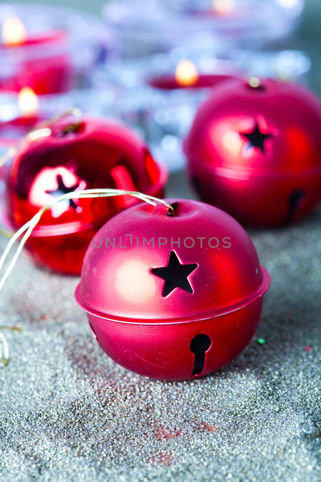 Close-up of jingle bell Christmas baubles with candles