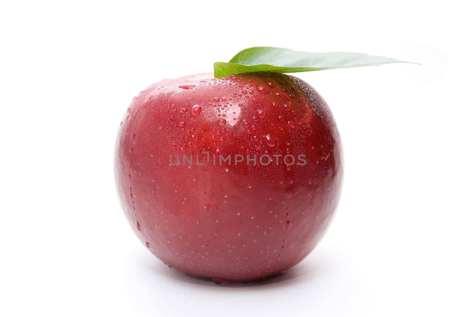ripe fresh red apple with leaf isolated on white
